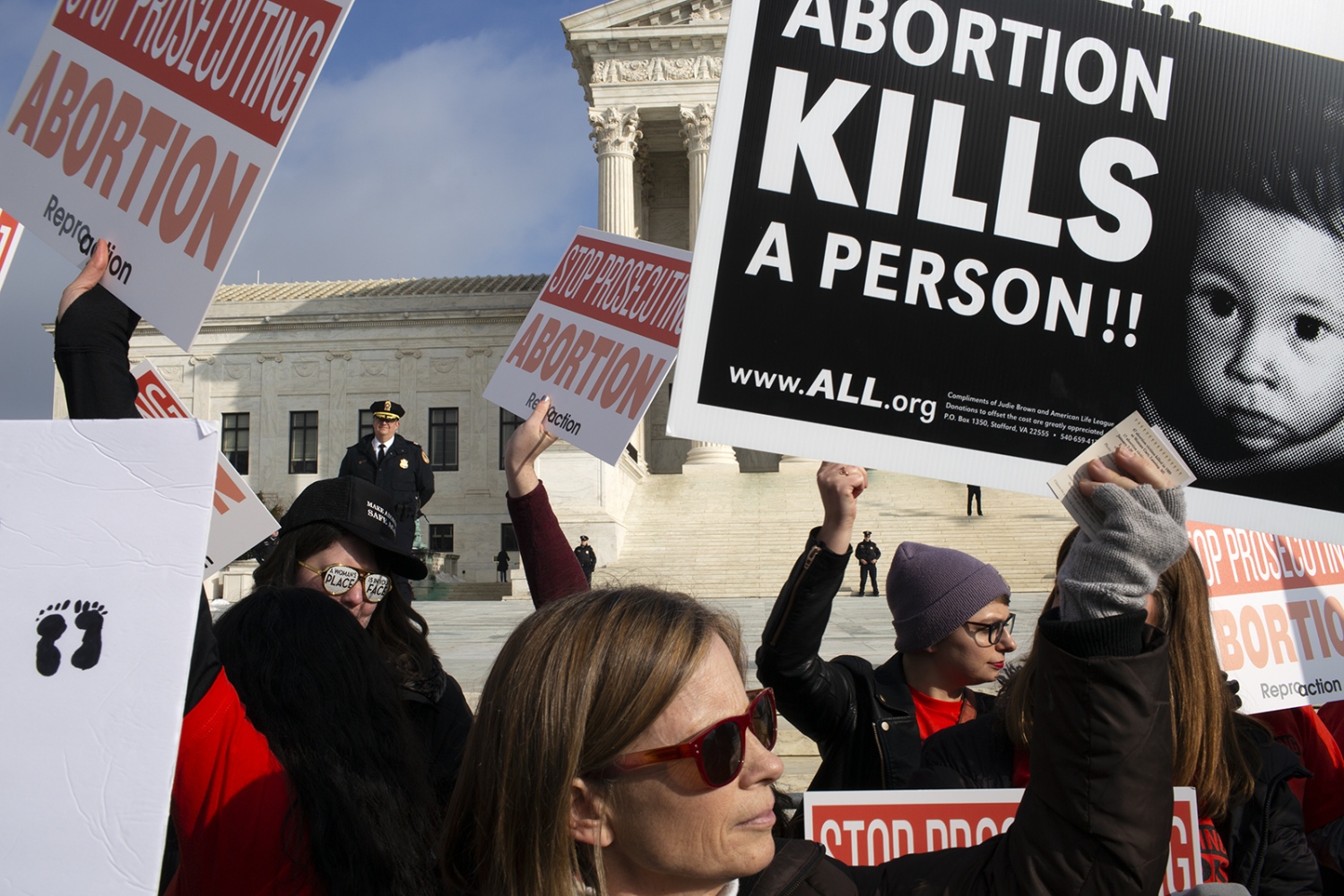 Pro-life and Pro-choice marchers mix on the Supreme Court campus.