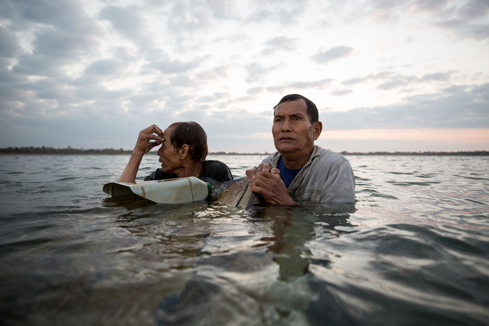 WHAT LIES BELOW SHOULD STAY BELOW - Thai villagers Por Lua and Por Wikan (left) anxiously...