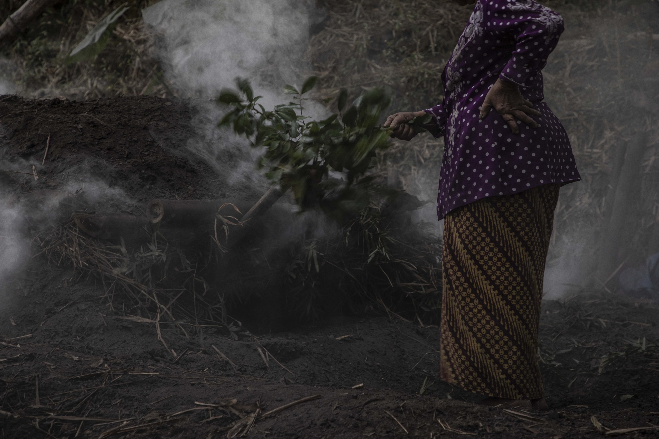 The Brave Women of Mount Merapi -  It takes Mbah Sudiwiyono 3 days to produce charcoal. She...