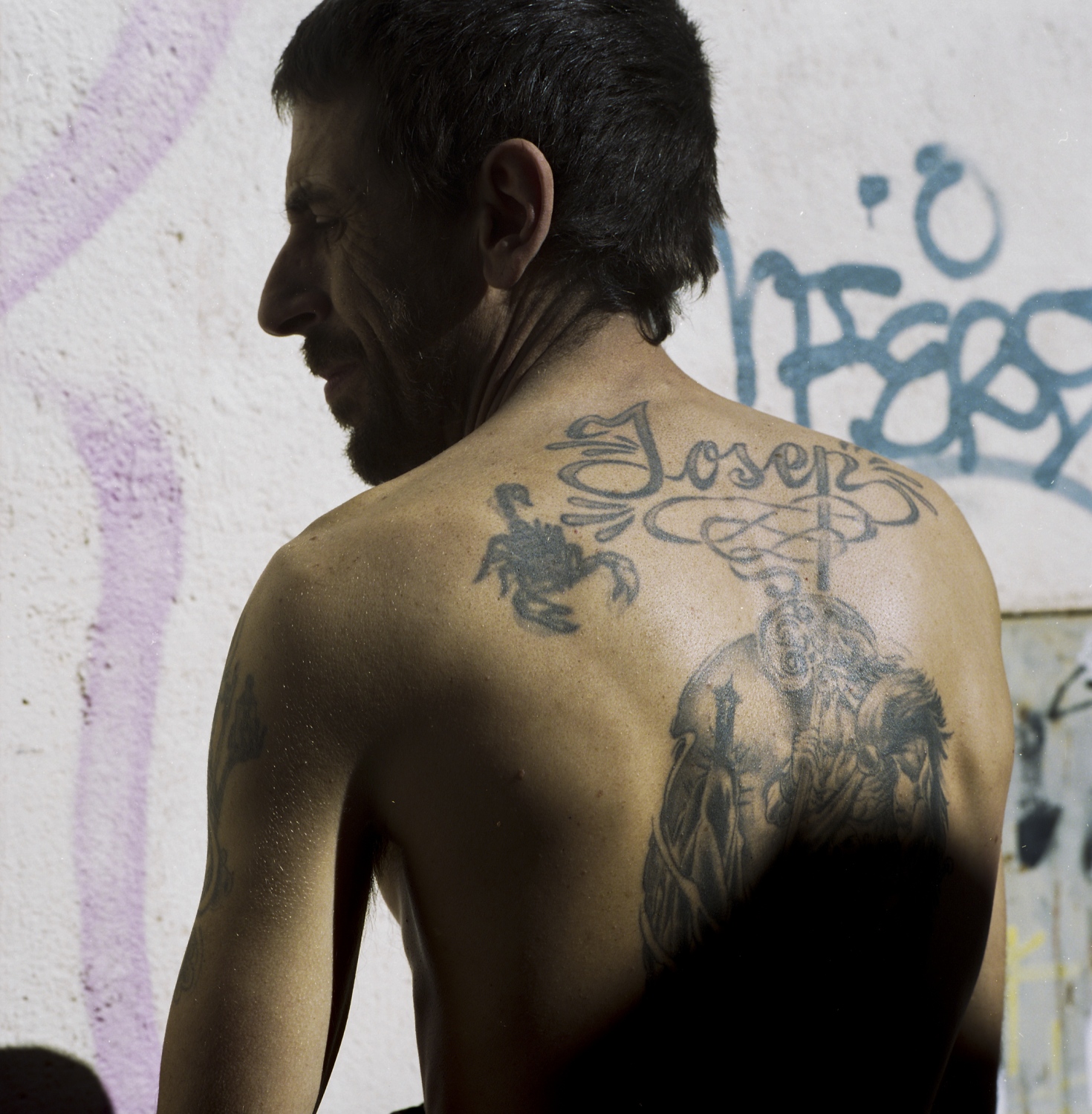 Jose displays his son&rsquo;s name tattooed above a locksmith figure. Jose takes pride in...