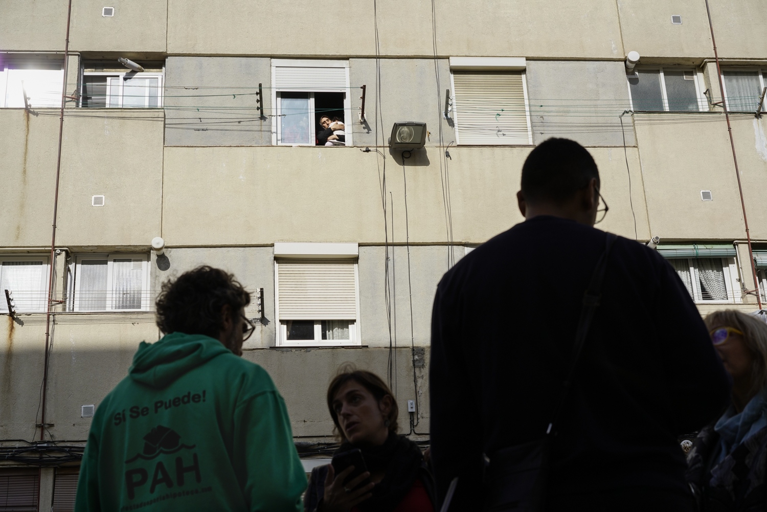 Abdel Fatam&rsquo;s family stands at the window of their apartment in the working class Nou...