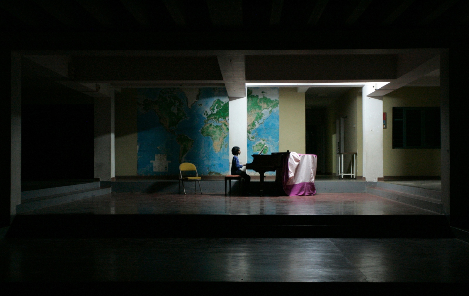 Manjula, 12, practices piano in the main school building.