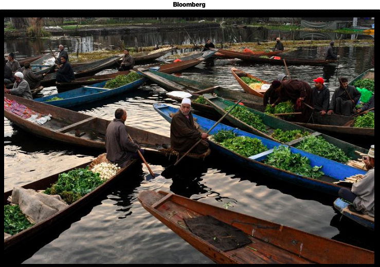 Vegetable vendors sit in boats ...Bloomberg &nbsp; &nbsp;