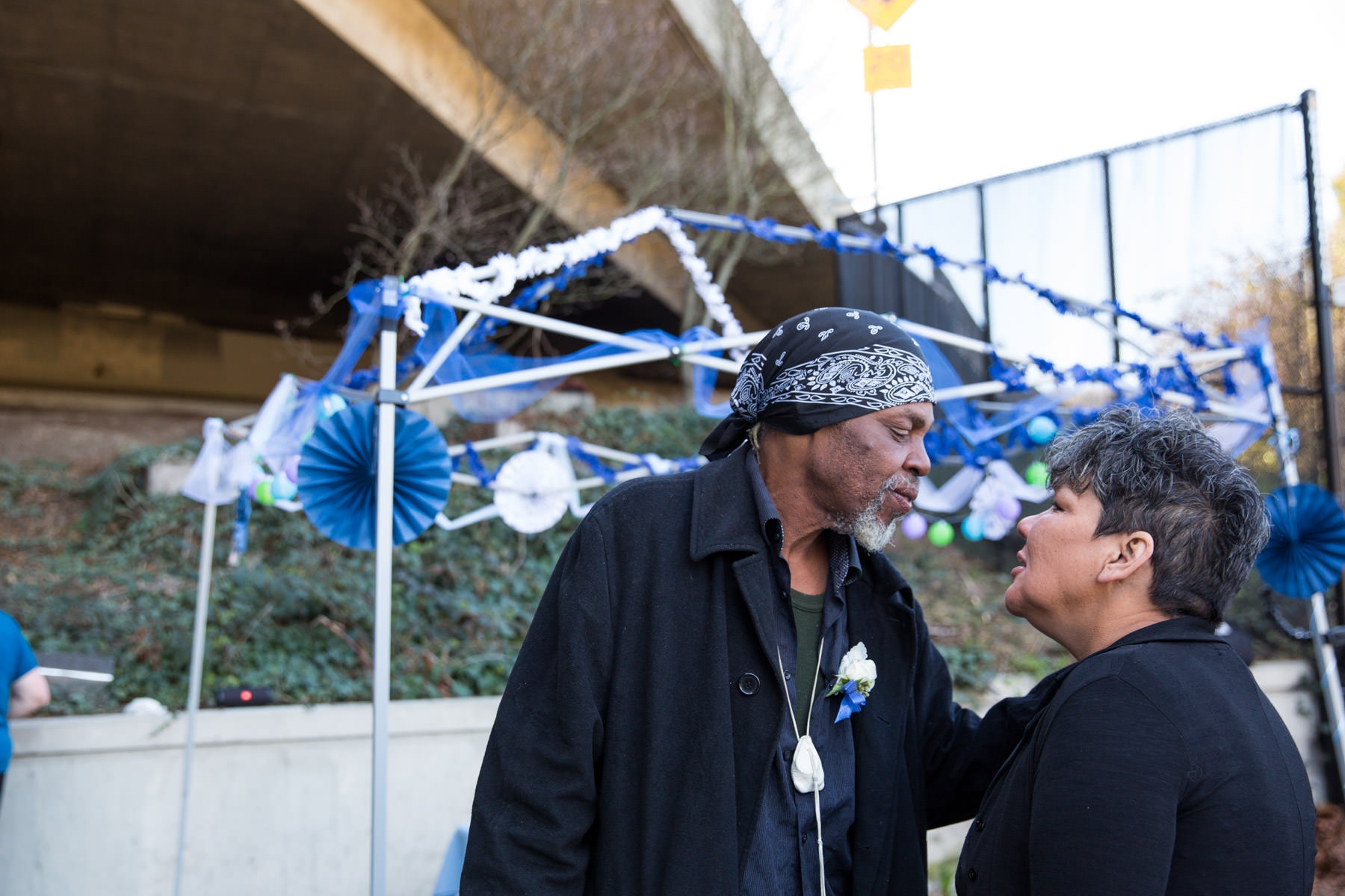 Michelle Vestal and Bob J. Kitcheon, who live in a tent community, share a kiss under the freeway in Seattle, where they married on March 18, 2018....