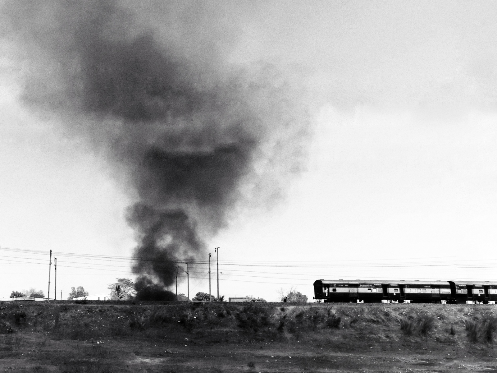 A train passes by a huge smoke ...een taking place in the region.