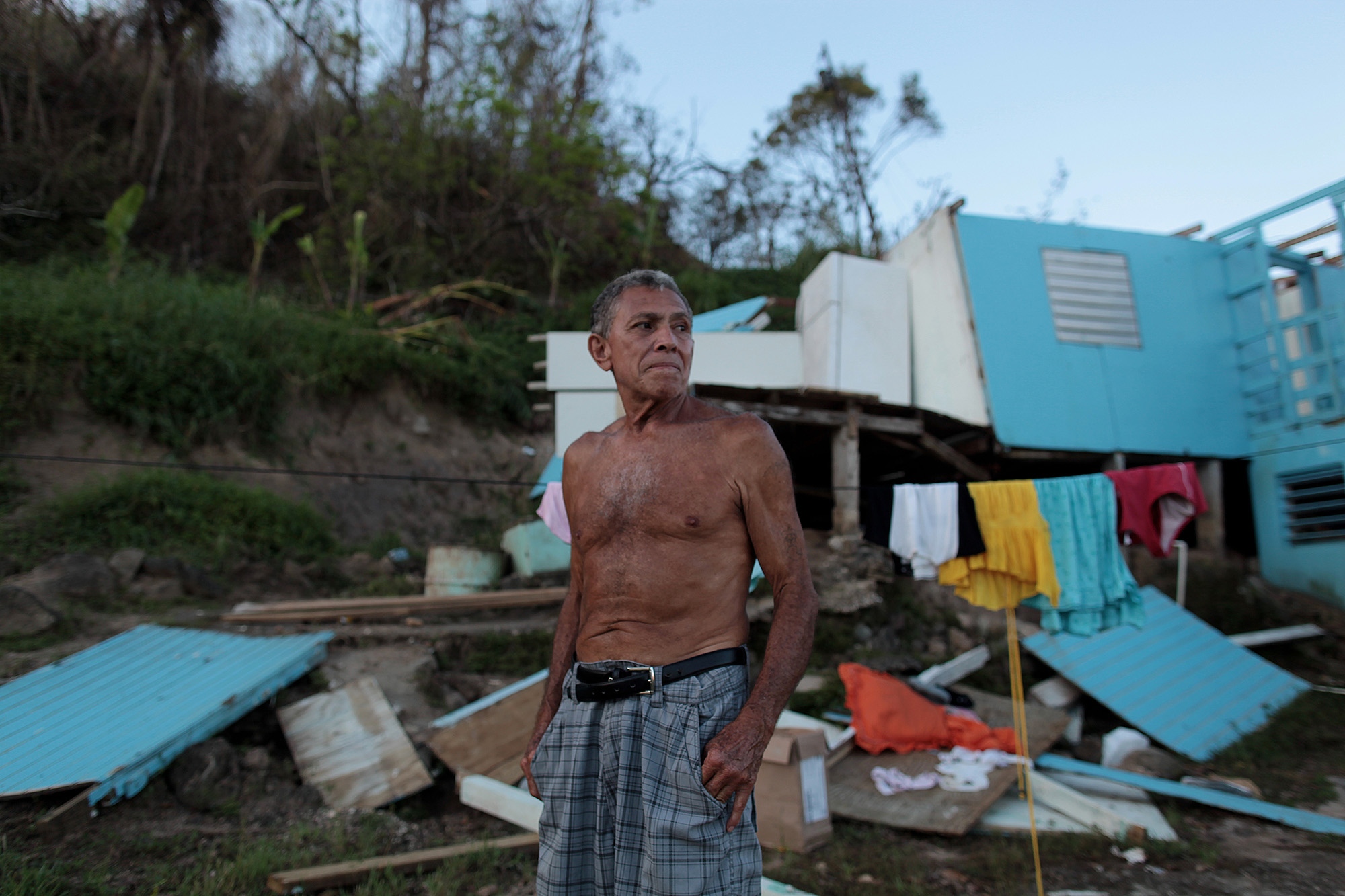 Destroyed bridge imperils village cut off by Hurricane Maria