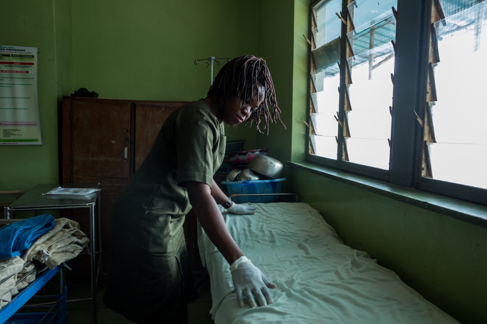  Zainab preps a bed to be used ...ity College, Hospital, Ibadan. 