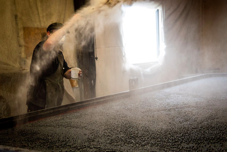 A worker adds grit to a rotatin...grapher: Cate Dingley/Bloomberg
