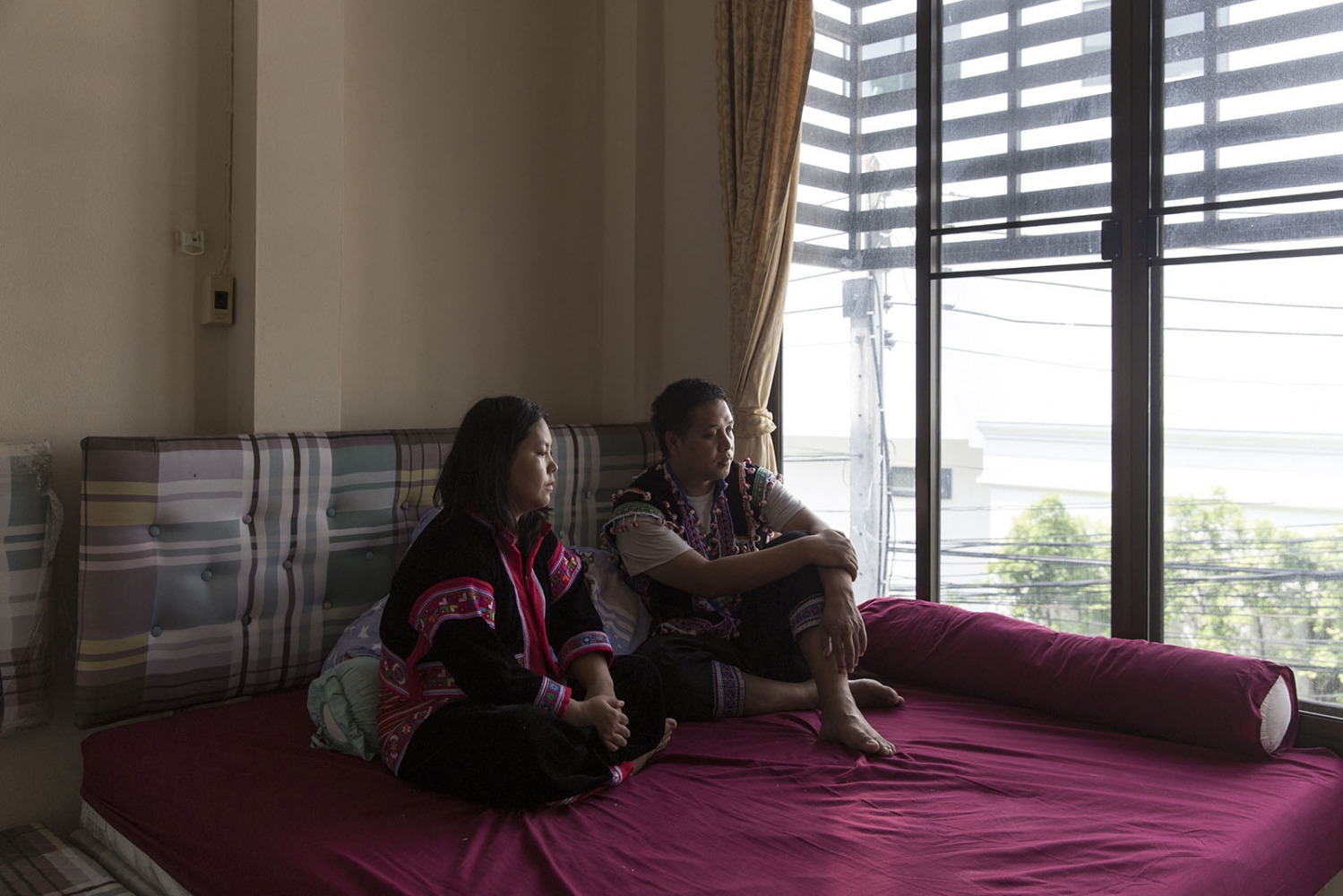 Maitree Chamroensuksakul (right) and Yuphin Saja (left) sit in a safe-house in northern Thailand. Maitre and his wife, including 2 small children have been living in 3 different safe houses since 2017 after the death of Chaiyaphum Pasae, their adopted son, for fears of reprisals during their fight for justice. Northern Thailand