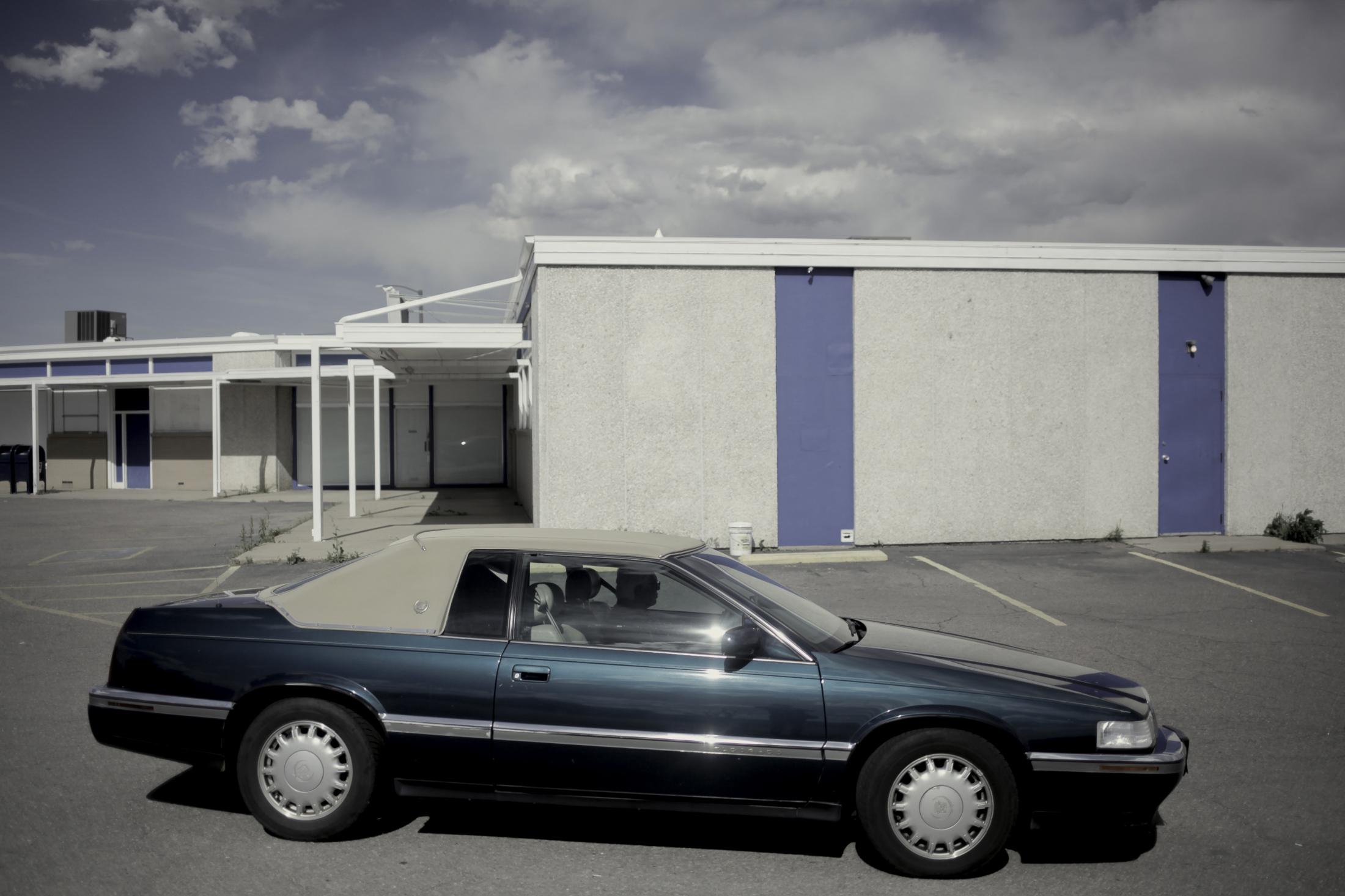 A parking lot in an abandoned strip mall. Denver, CO. 2018.