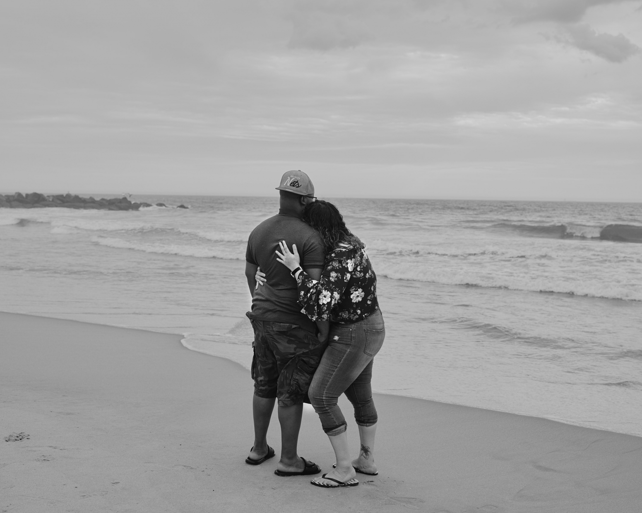 ROCKAWAY (Ongoing) - A couple snuggles in front of the ocean. New York, 2019.