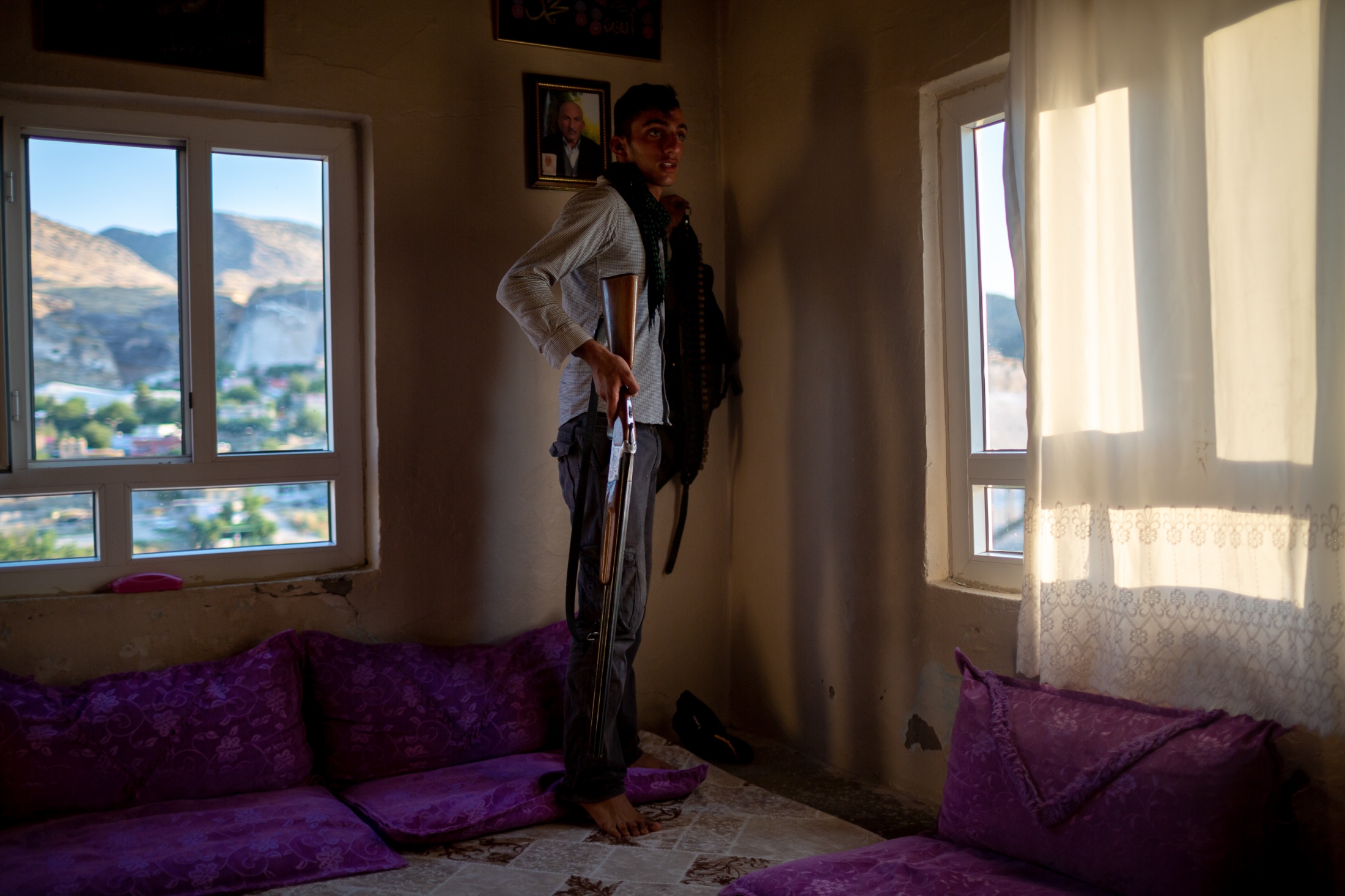 A resident of a village adjacent to Hasankeyf shows off his hunting gun. While the village across the Tigris river from Hasankeyf will not be submerged, the residents believe they will have to move because the settling ground will destabilize the surrounding structures,
