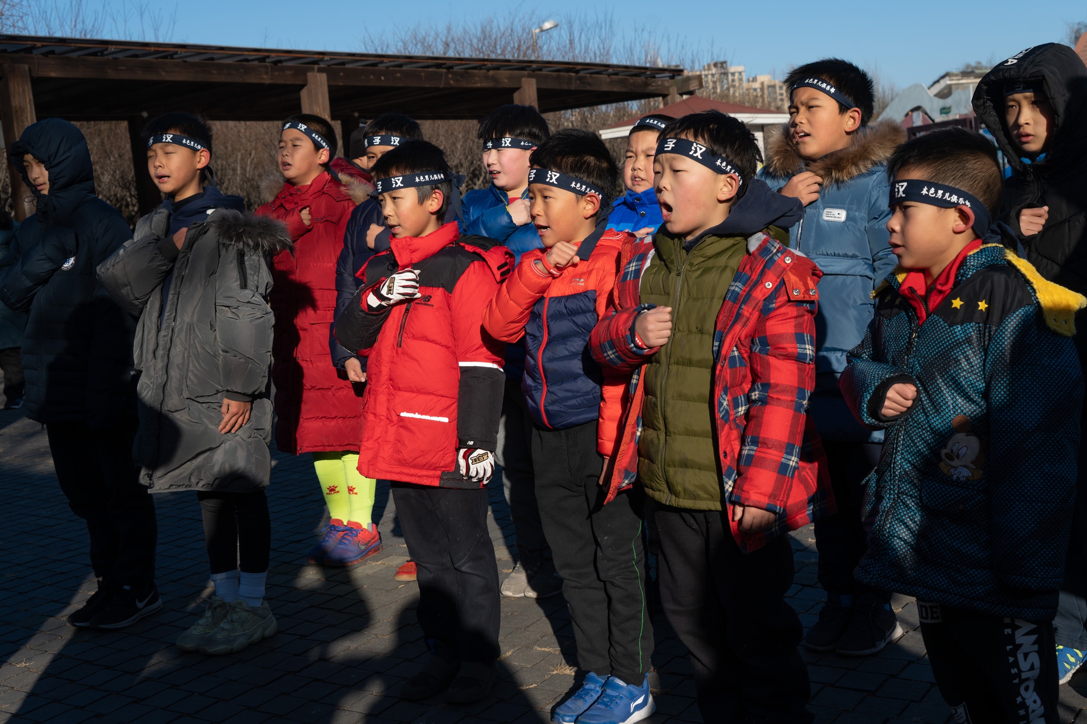  Boys pledge and chant before stripping to the waist for a run through a freezing Beijing park. 