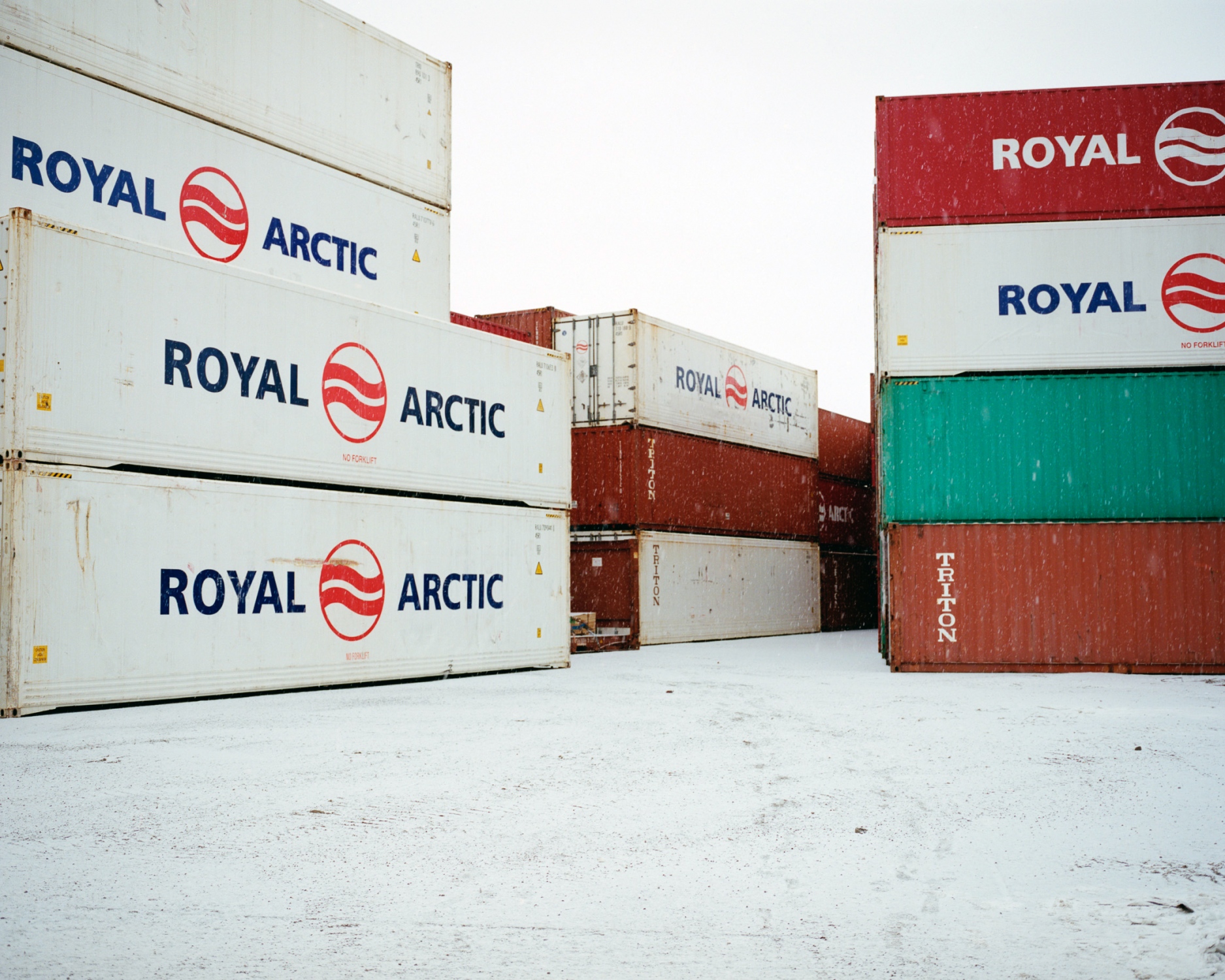 Whiteland - November in Tasiilaq. The last containers are brought...
