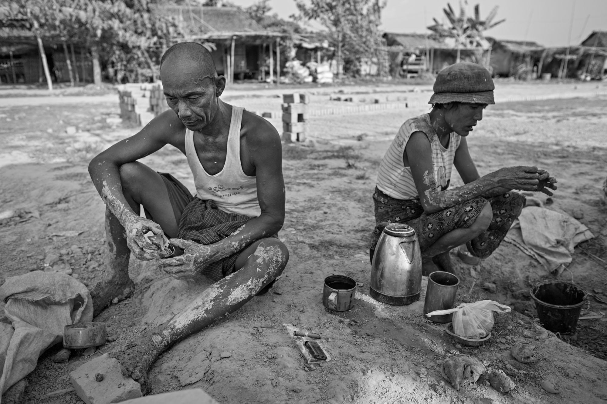 Built On Their Backs -  Naing Lin and his wife Than Nwe rest in the shade,...
