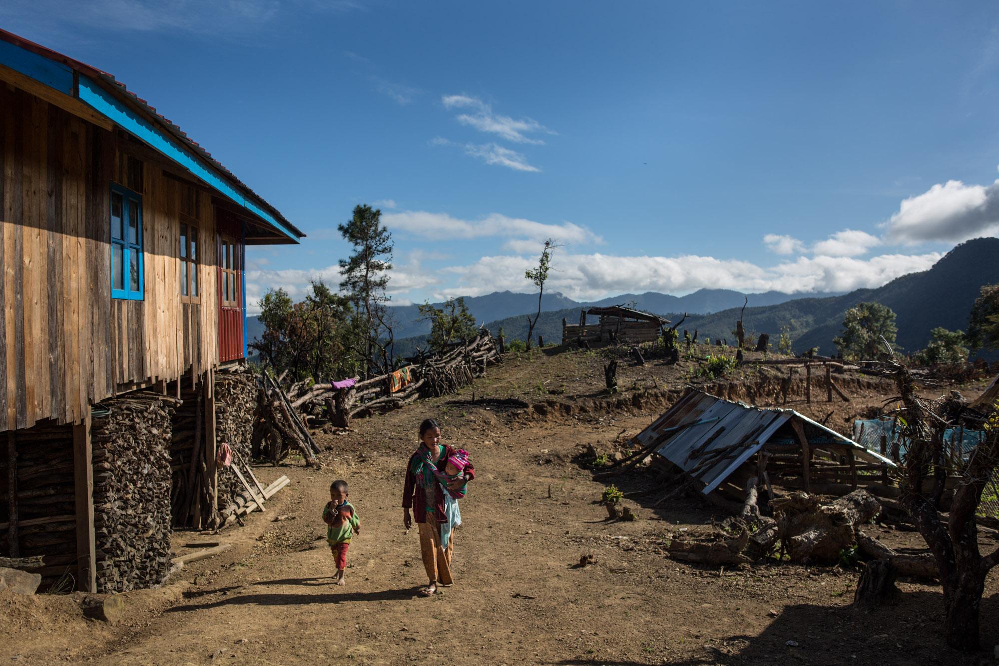 A mother and her two daughters walk through their village in rural Chin state, Myanmar, November 2015.