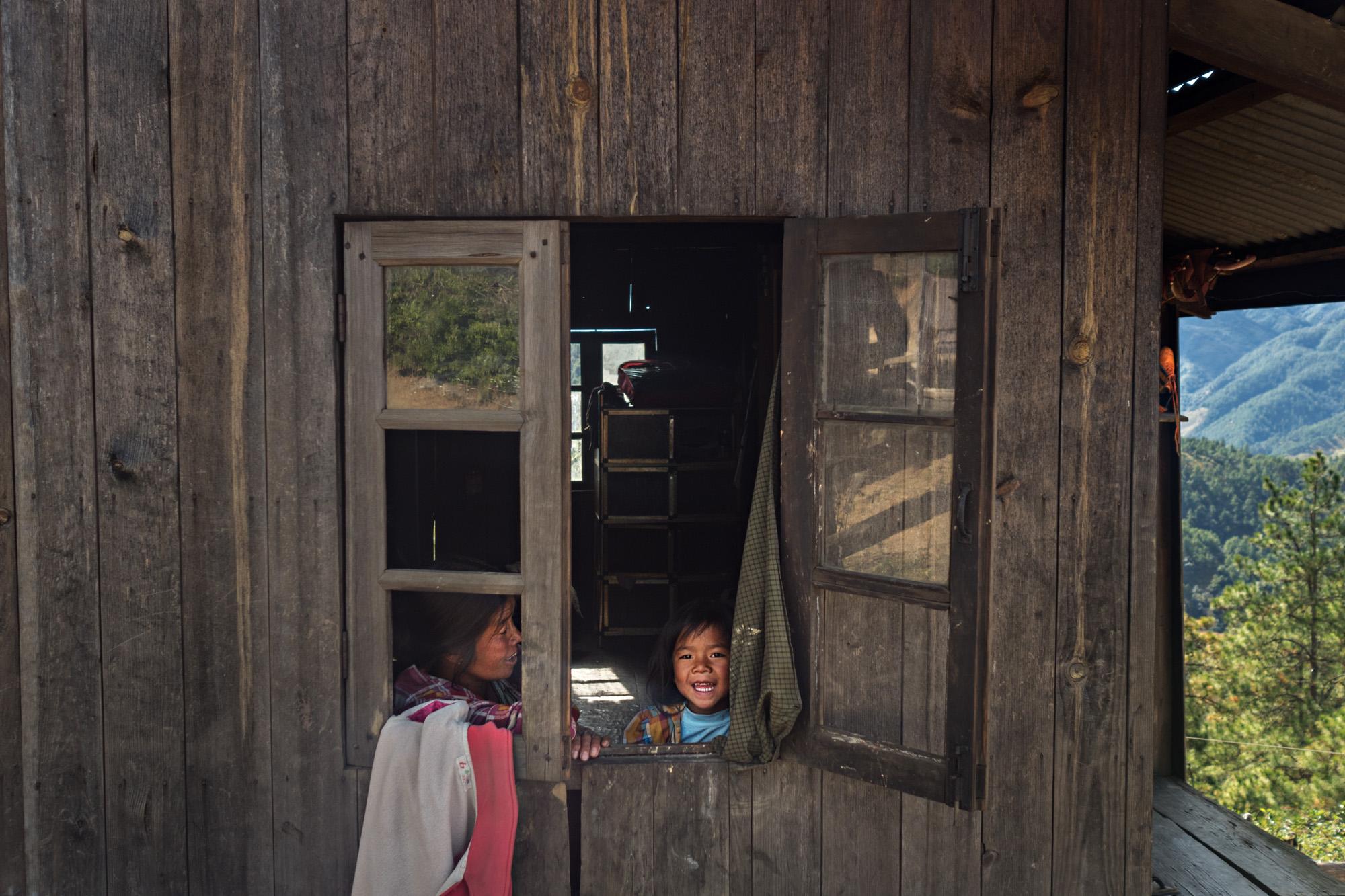 NGO - A child looks out her window in rural Chin state,...