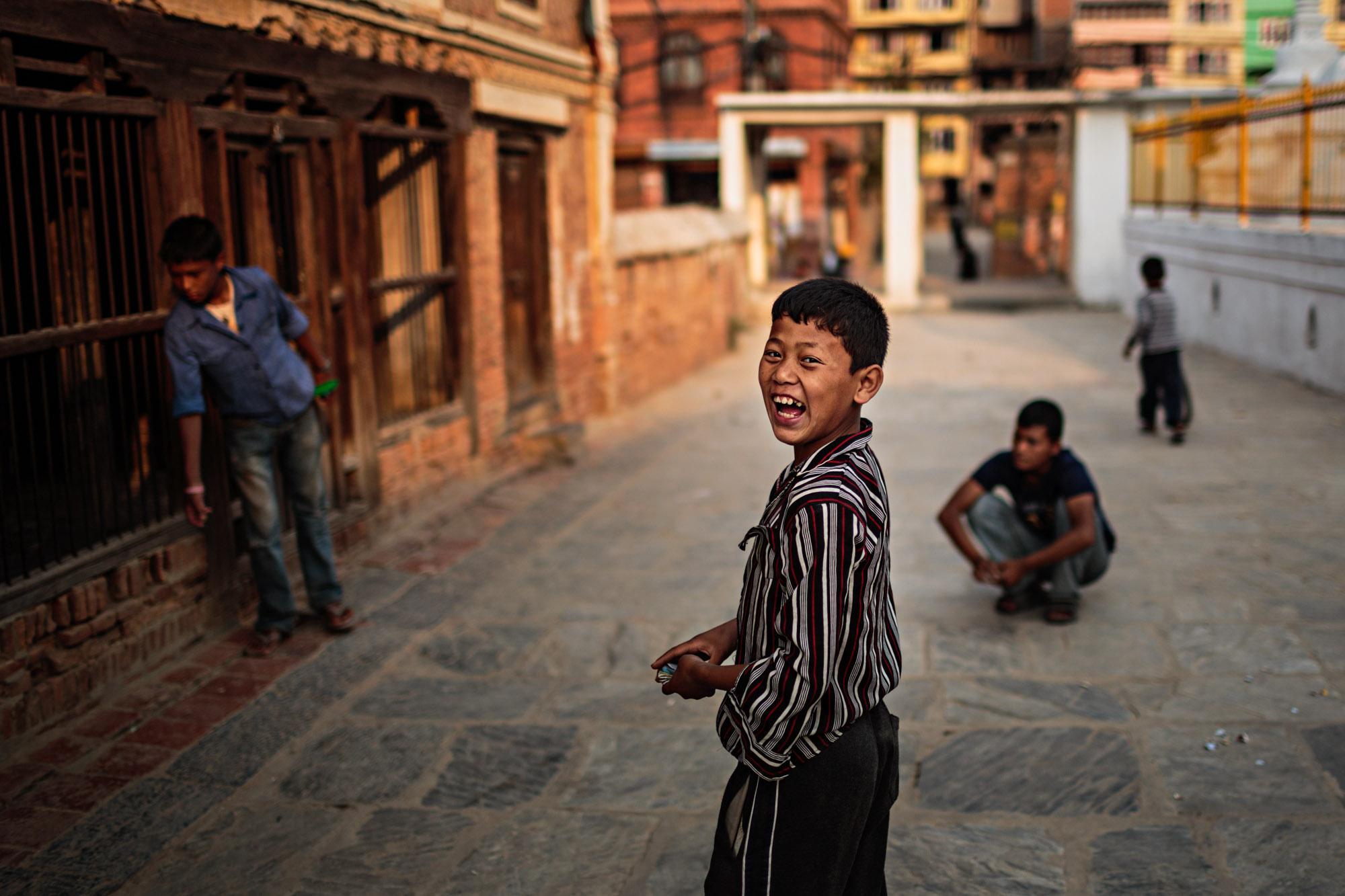 Travel - A boy laughs while playing a game with his friends in...