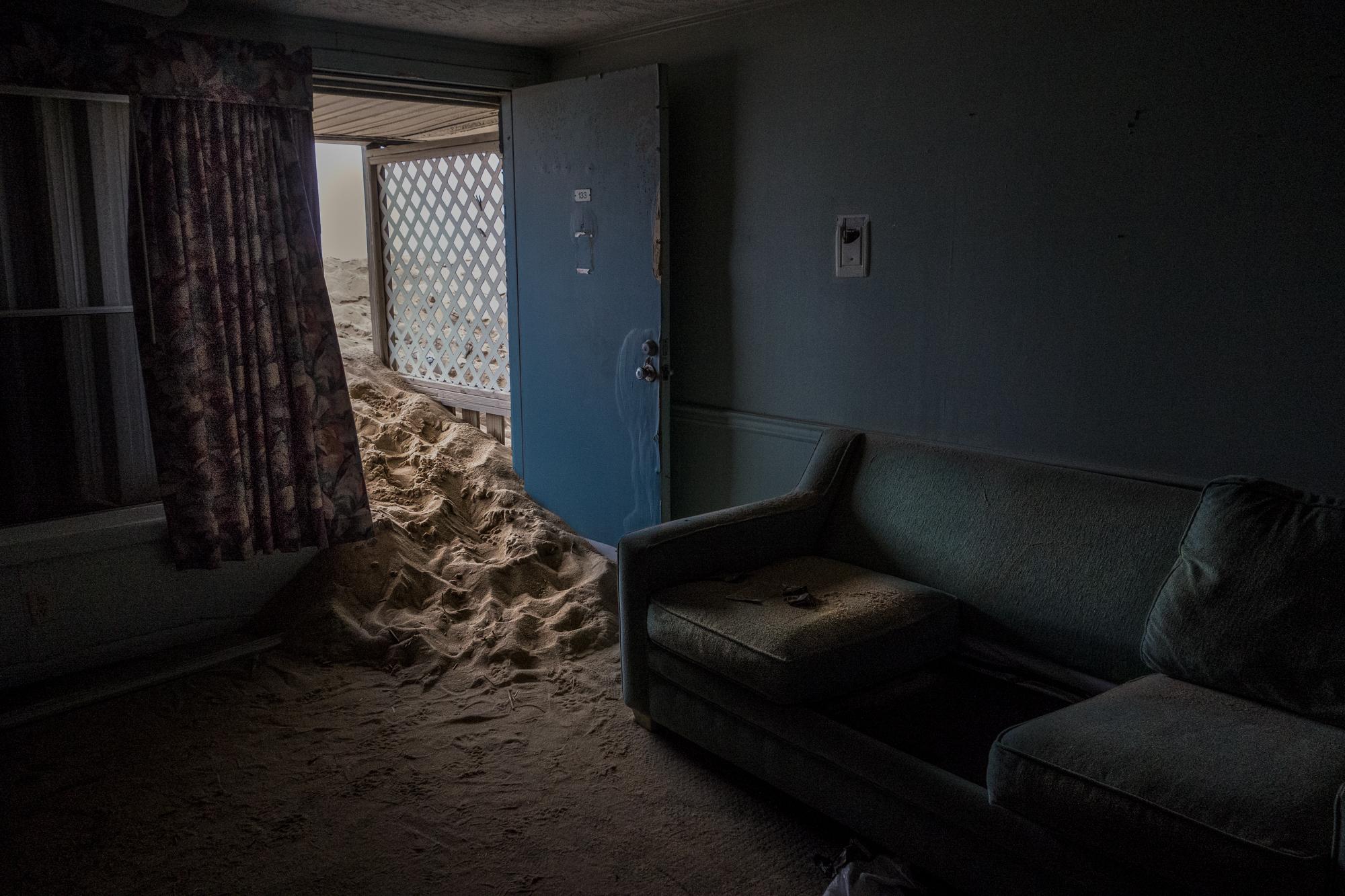 Shifting Sands - Sand encroaches into a room of the now demolished Beacon Motor Lodge in Nags Head, North...