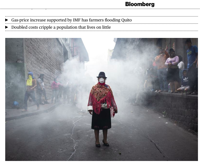 An indigenous woman wears a mas...her: David Diaz Arcos/Bloomberg