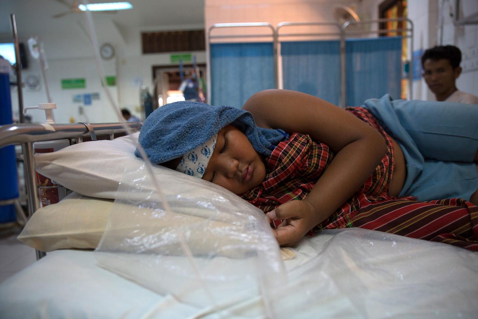 SOUTHEAST ASIA'S DENGUE EPIDEMIC - Chan Pheakdey, 10, lies in bed a hospital bed in the...