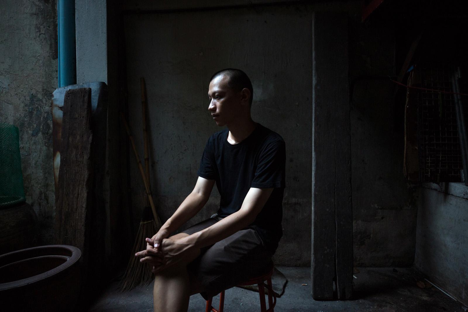 SOUTHEAST ASIA'S DENGUE EPIDEMIC - Jaturang Wongjiragorn, 28, sits in the dark alleyway...