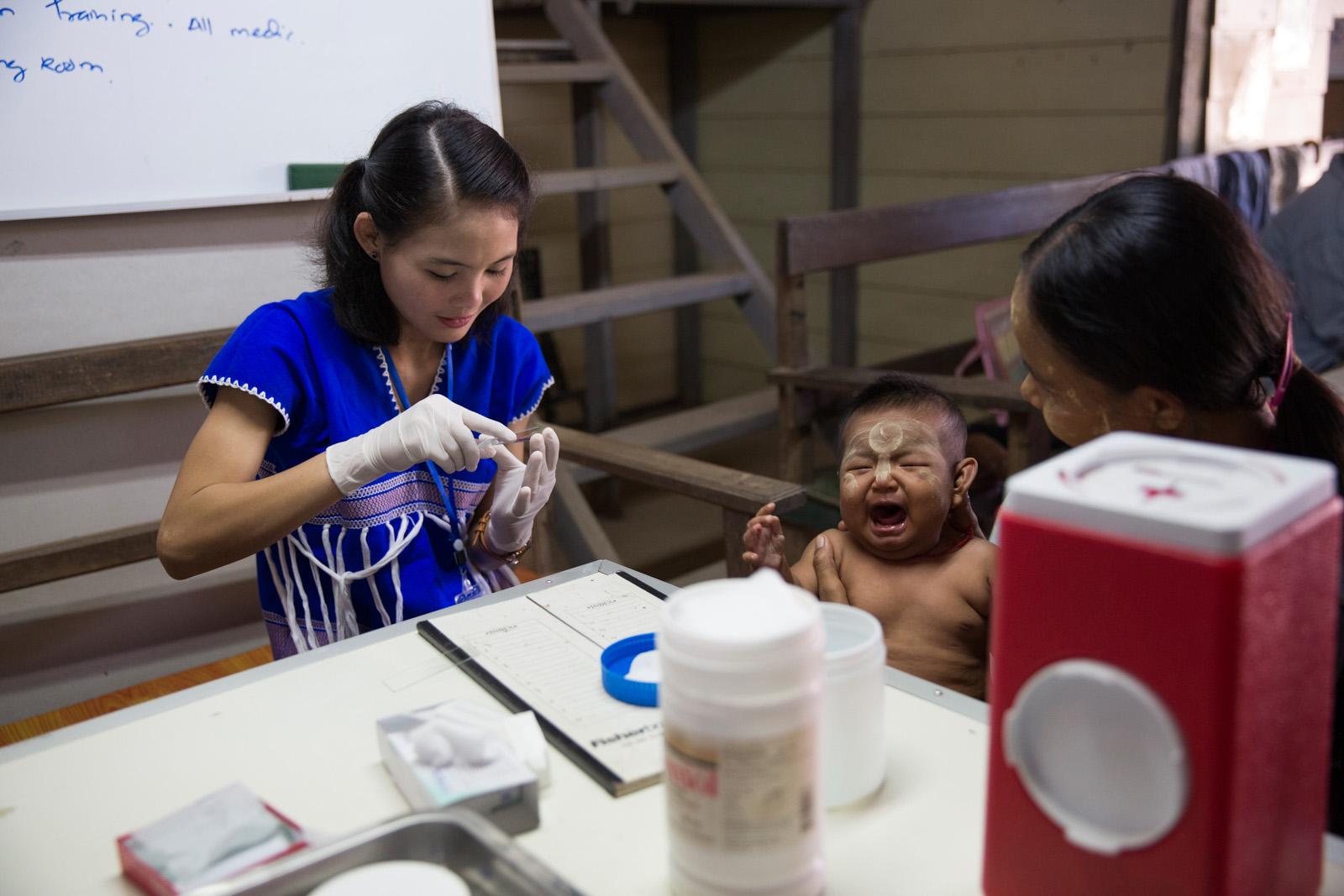 SOUTHEAST ASIA'S DENGUE EPIDEMIC - A sick Burmese baby has a blood sample taken at the Mae...