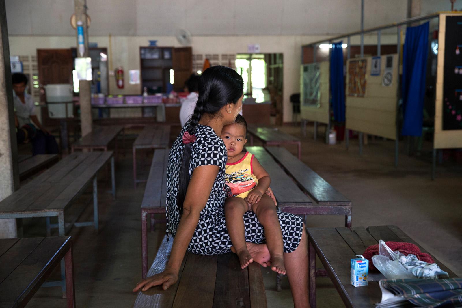 SOUTHEAST ASIA'S DENGUE EPIDEMIC - A sick Burmese child is comforted by his mother whilst...