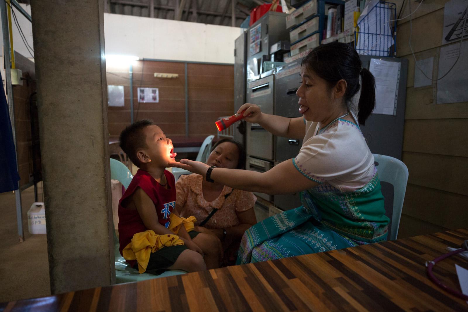 SOUTHEAST ASIA'S DENGUE EPIDEMIC - Candy Beau, (right) a medic at the Mae Pa Clinic on the...