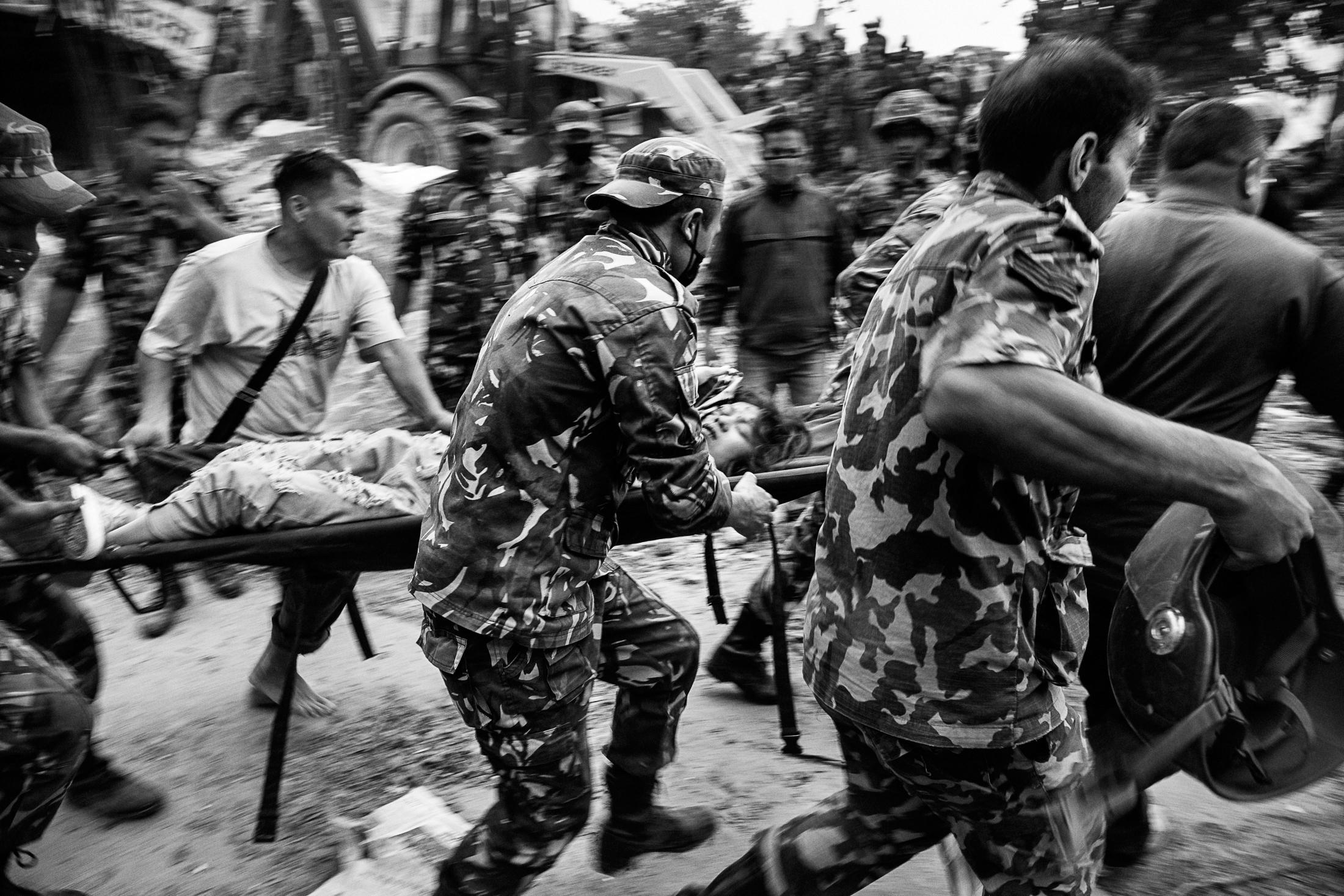 Endurance - KATHMANDU, NEPAL - APRIL 25: An injured woman is carried...