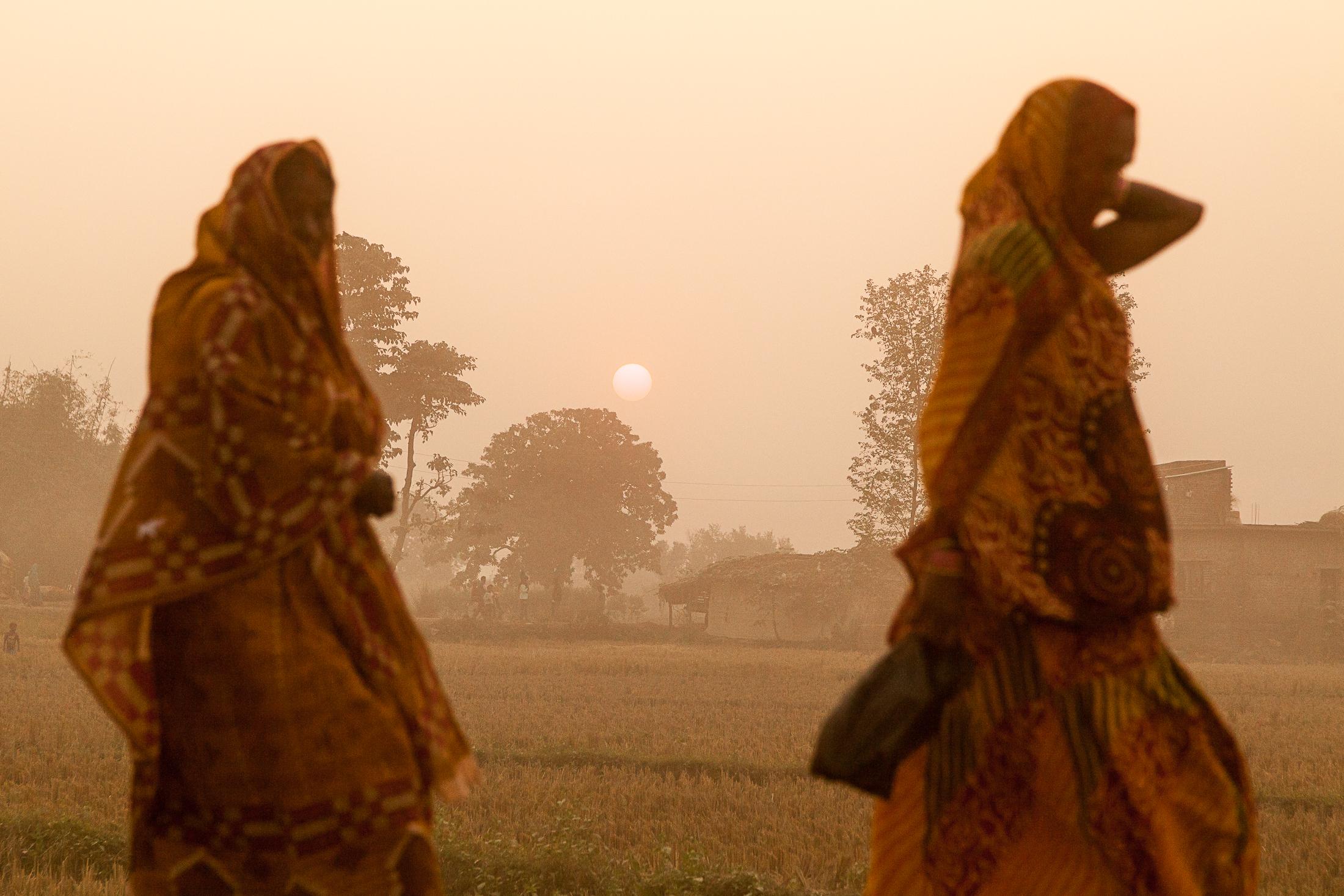 A Bloodbath in the Name of Gadhimai - BARIYARPUR, NEPAL - NOVEMBER 27: Two women walk along the...