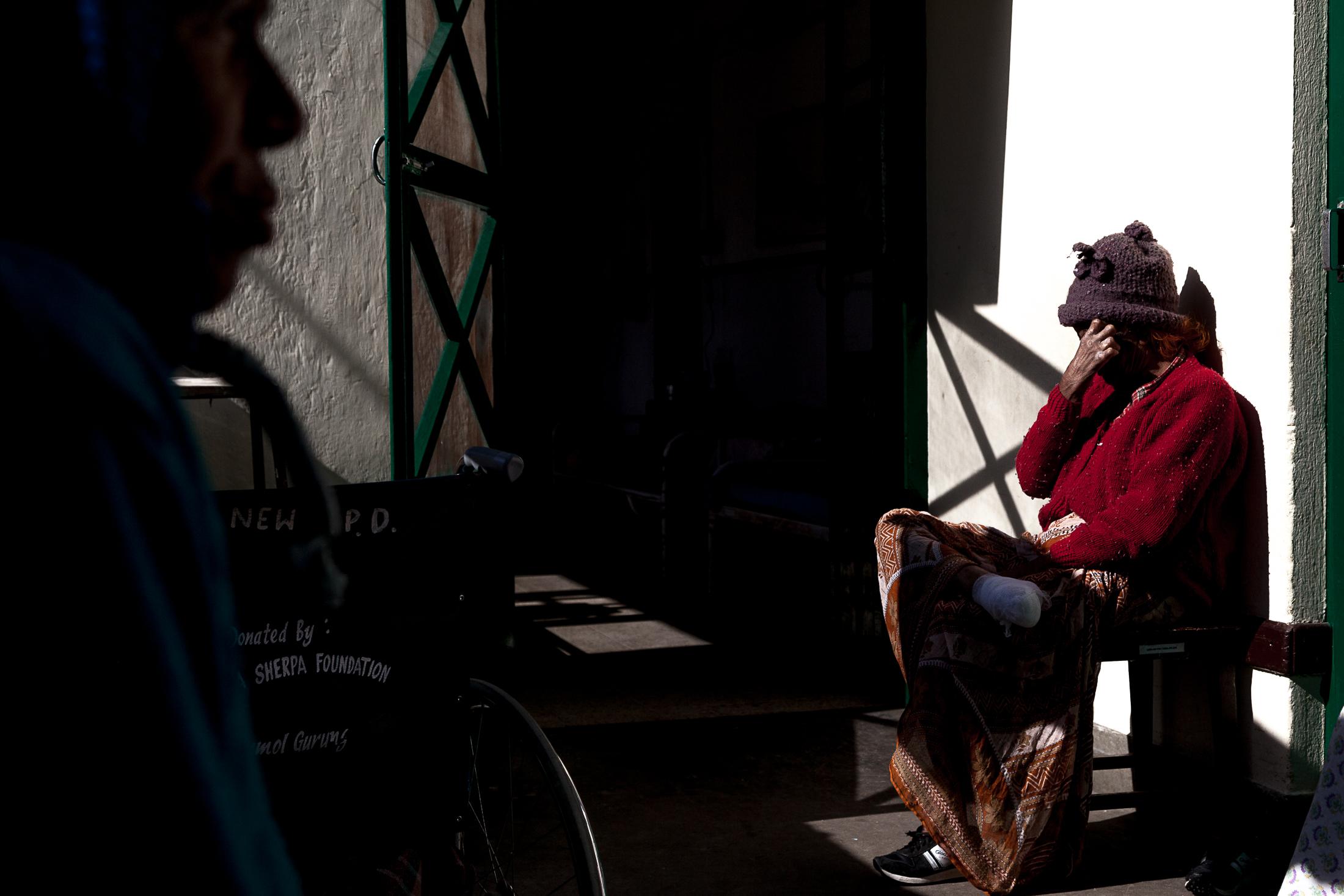 The Forgotten - LELE, NEPAL - JANUARY 24: A patient sits outside a ward...