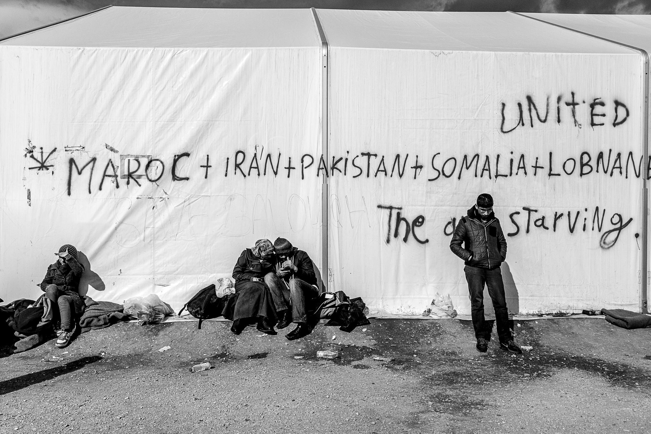 The Way - IDOMENI, GREECE - FEBRUARY 11: Refugees wait outside a...