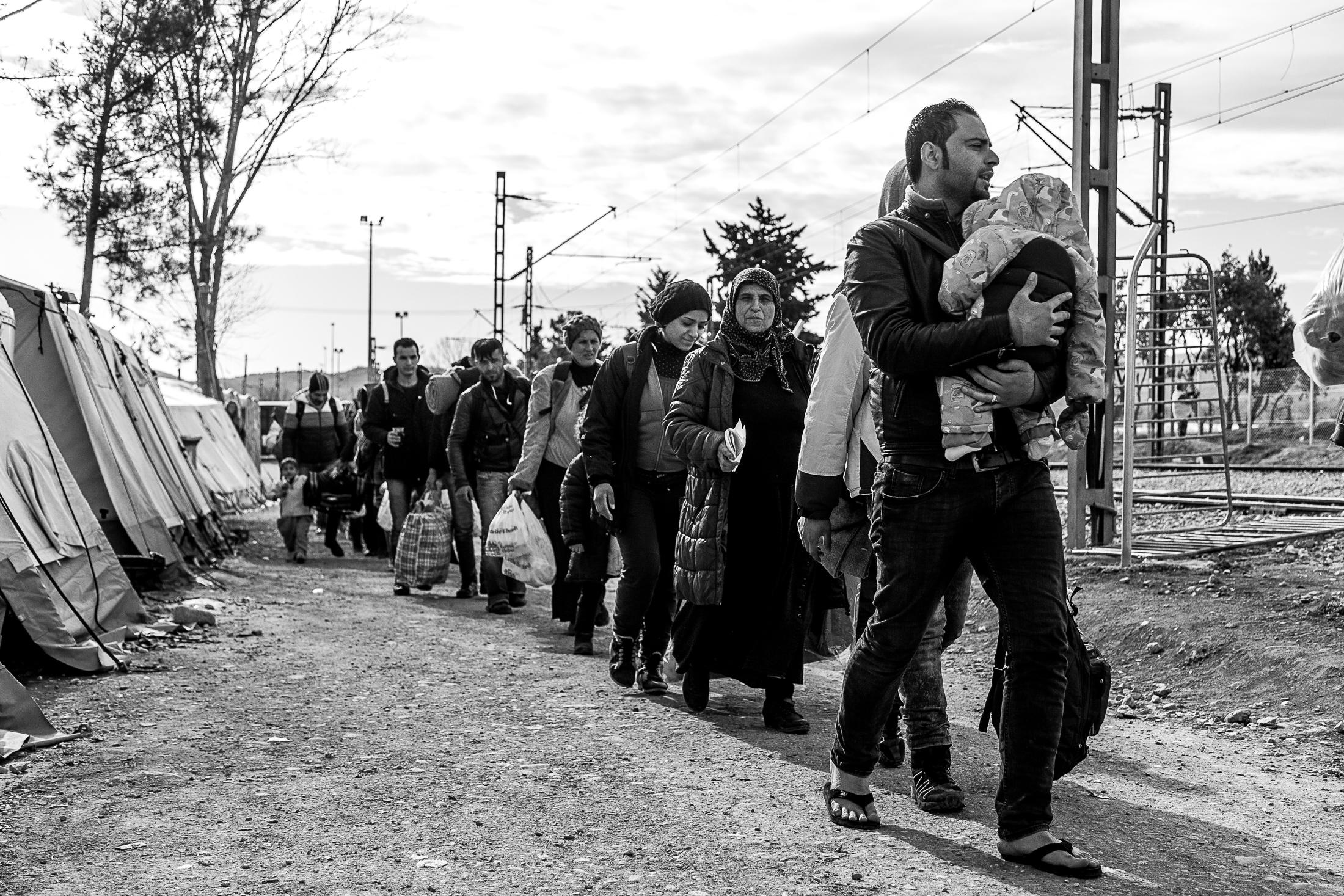 The Way - IDOMENI, GREECE - FEBRUARY 11: A group of refugees walks...