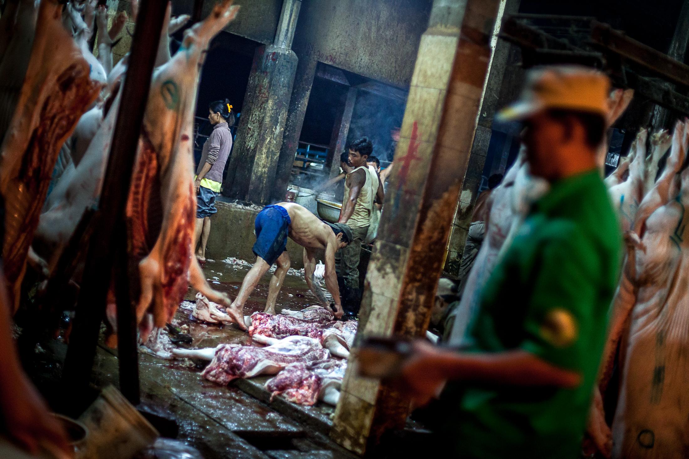 Inside a Cambodian Slaughterhouse - SIEM REAP, CAMBODIA - FEBRUARY 22: A worker removes the...