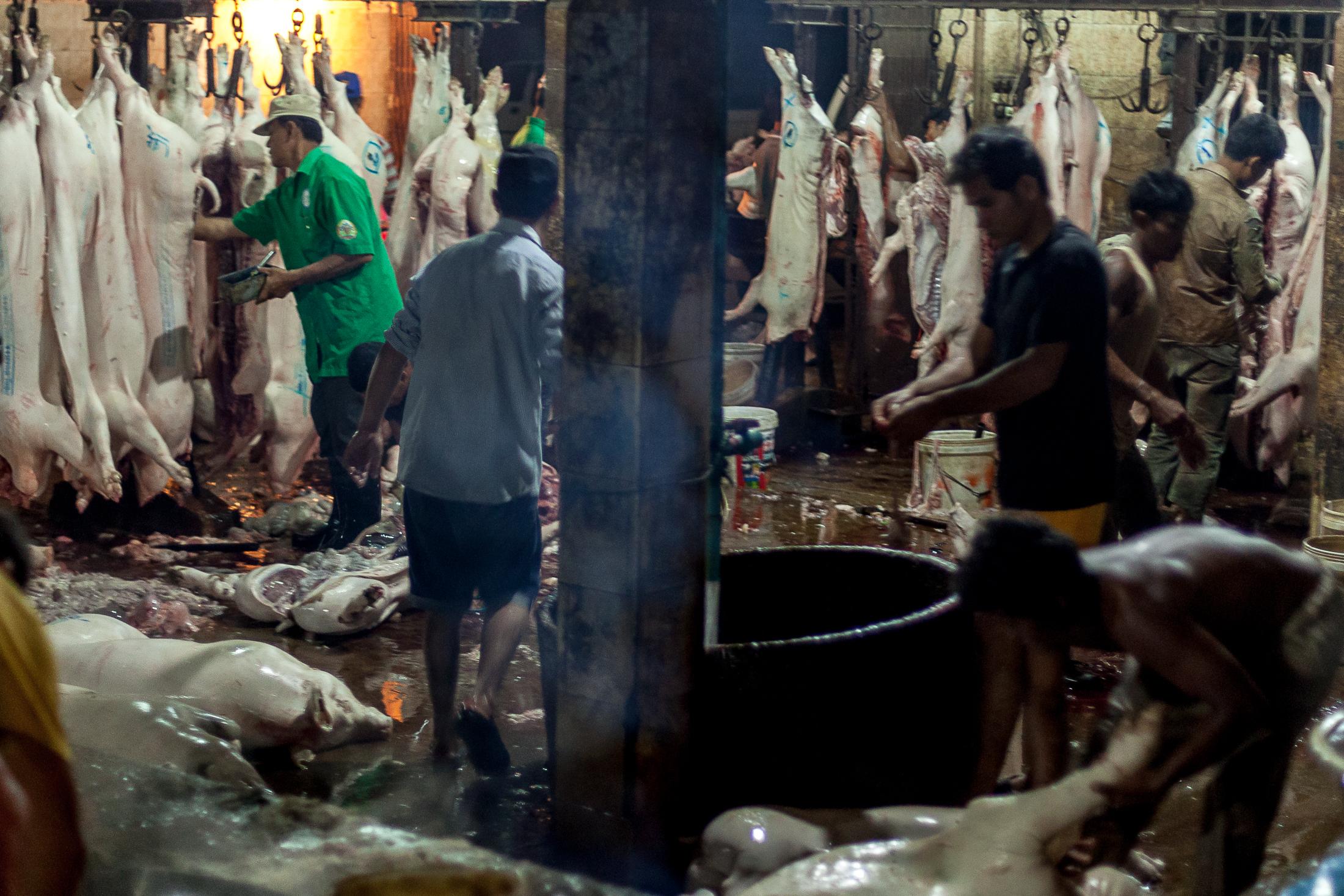 Inside a Cambodian Slaughterhouse - SIEM REAP, CAMBODIA - FEBRUARY 22: A group of workers...