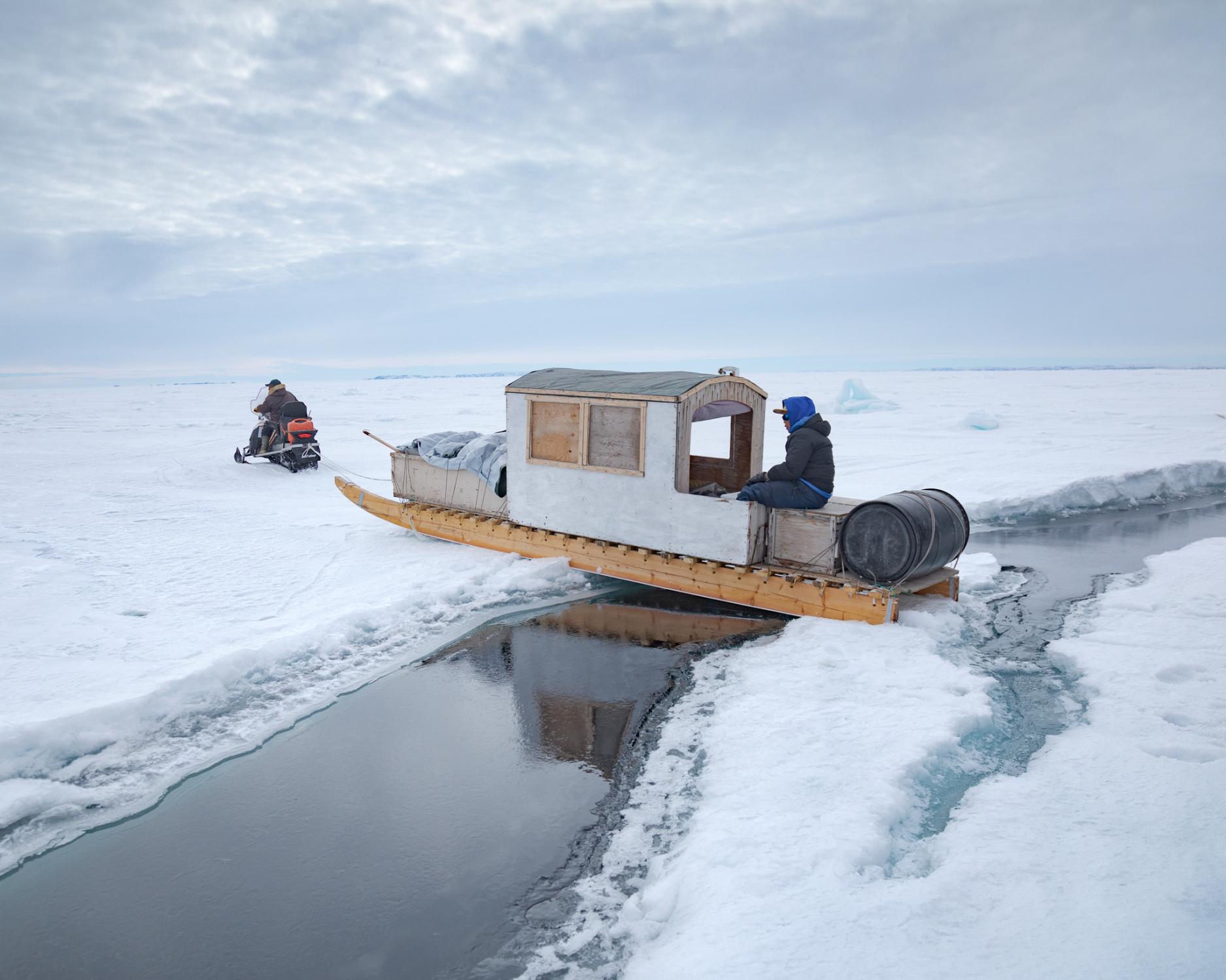 An open lead in the sea ice means a carefully orchestrated crossing for Olayuk Naqitarvik,...