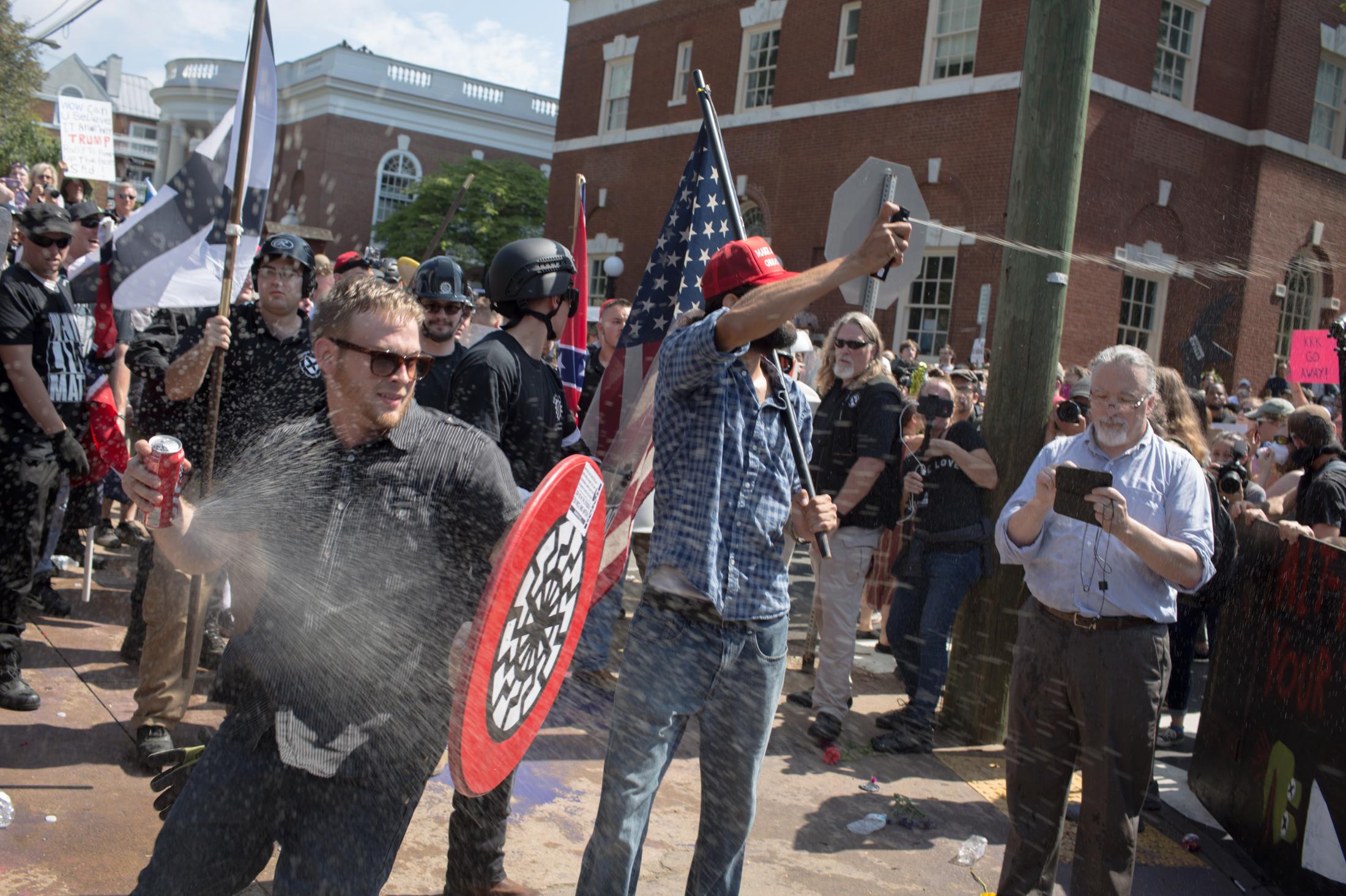 Charlottesville - A white supremacist protester sprays pepper spray at...