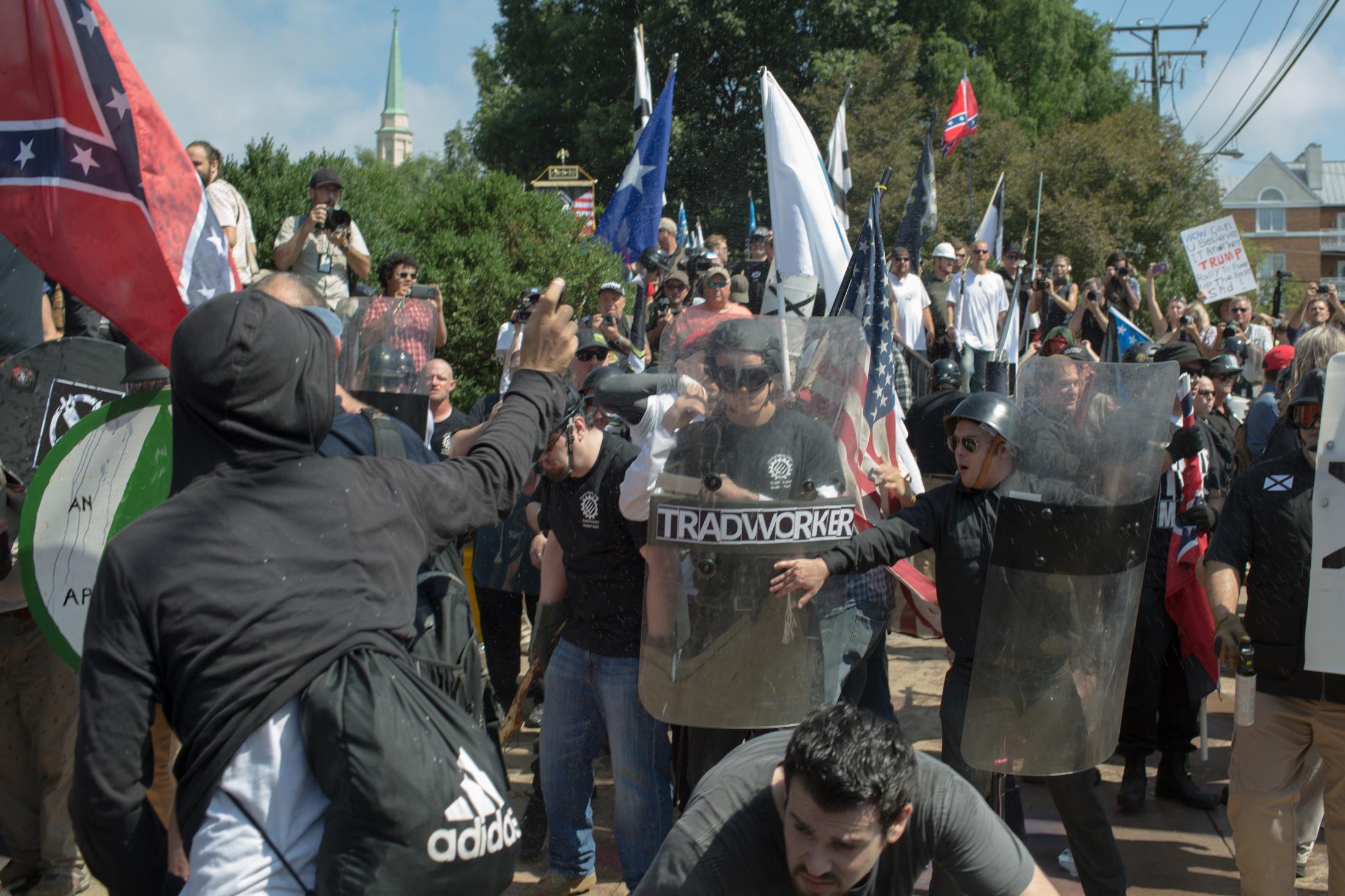 Charlottesville - An anti-fascist protester sprays pepper spray at white...