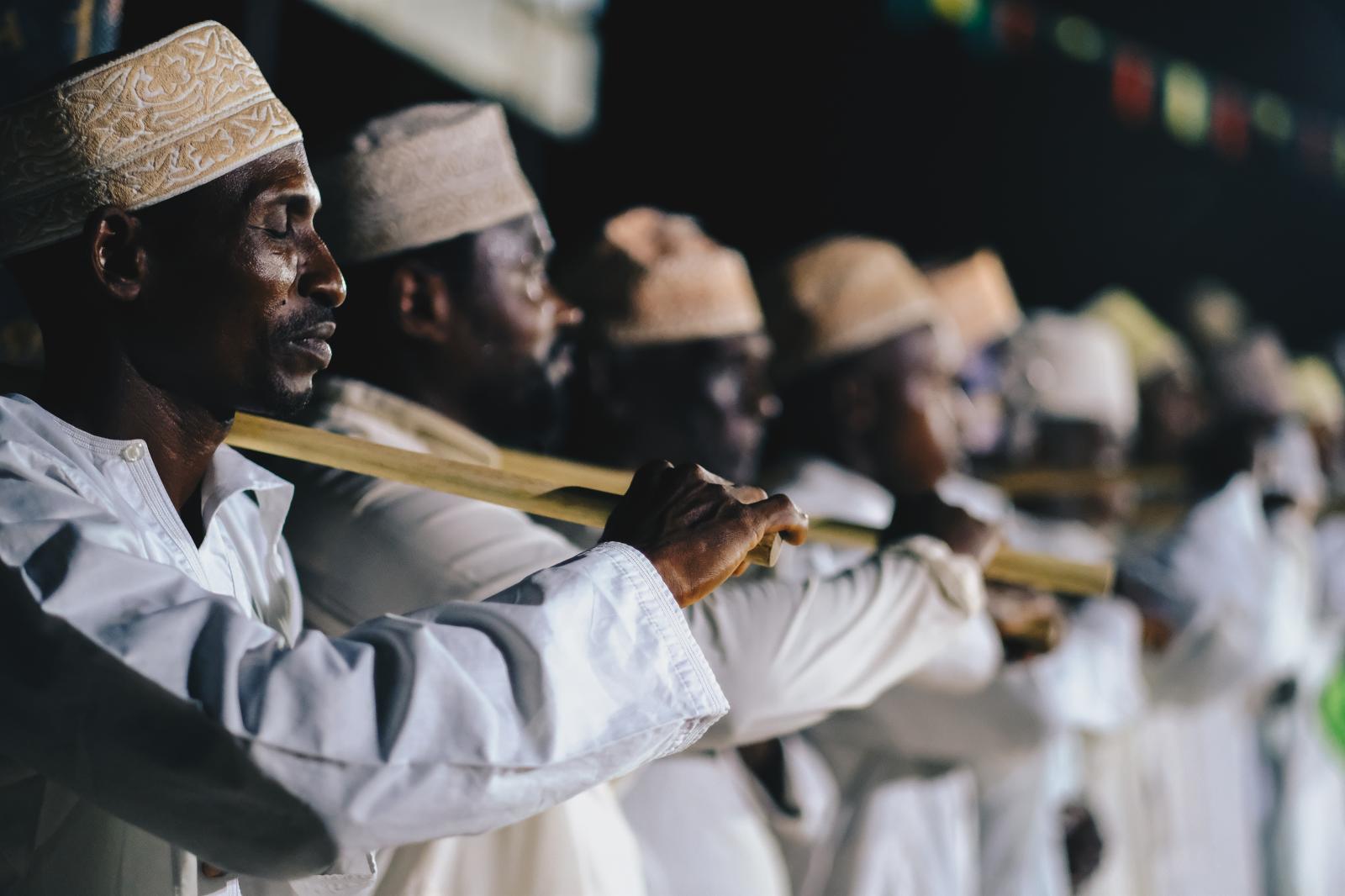 Men perform traditional songs that praise the Prophet Muhammad.