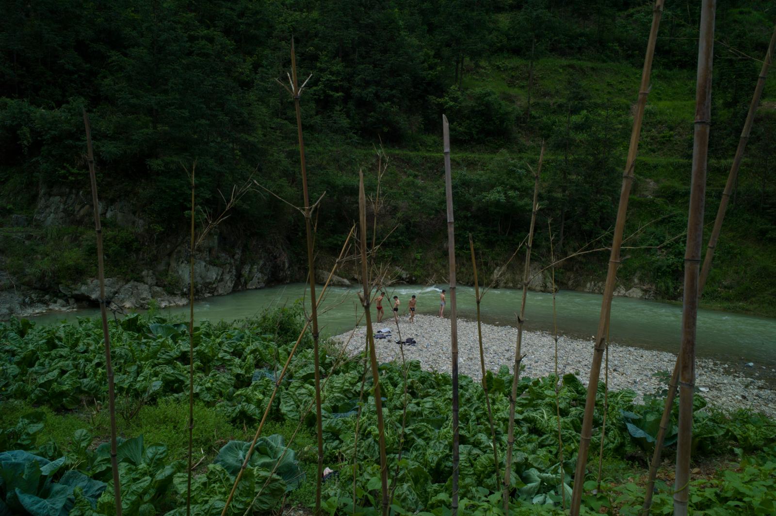 Youths from a nearby village swimming in the river.