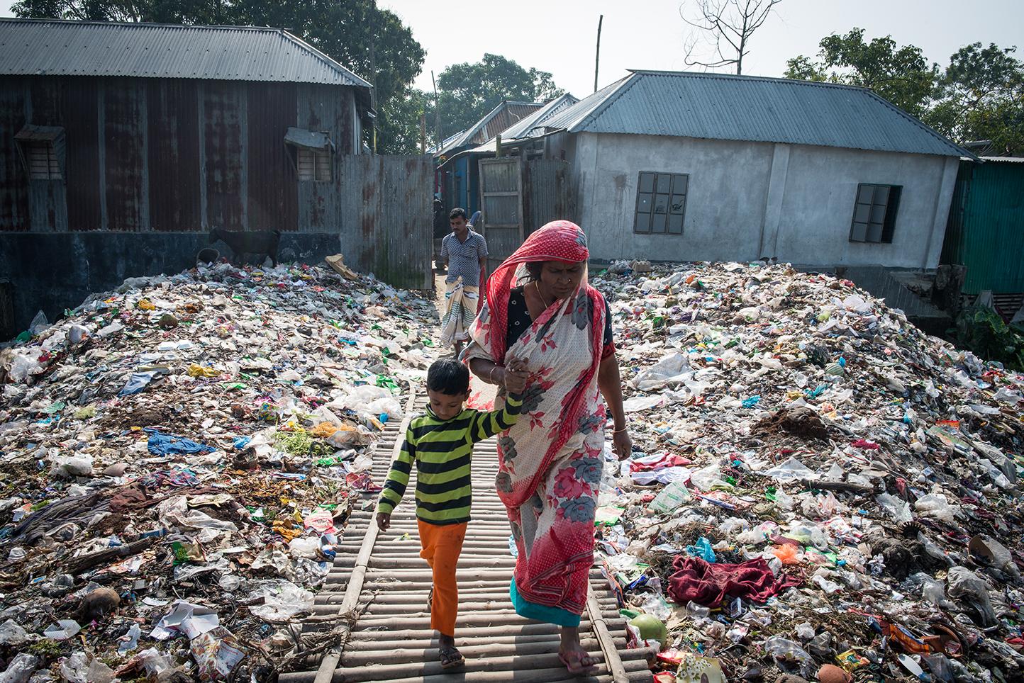 A sex worker and her son leave the back enterance of Daulatadia Brothel in Daulatadia, Rajbari,...
