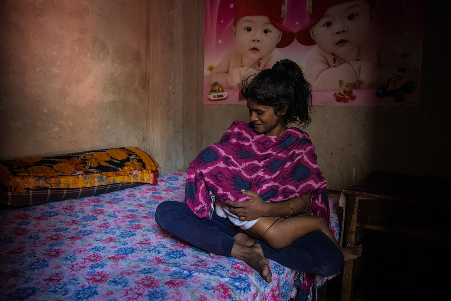 Tania, 15, with her son Thangil, 2, is a sex worker in Daulatadia Brothel in Daulatadia, Rajbari,...