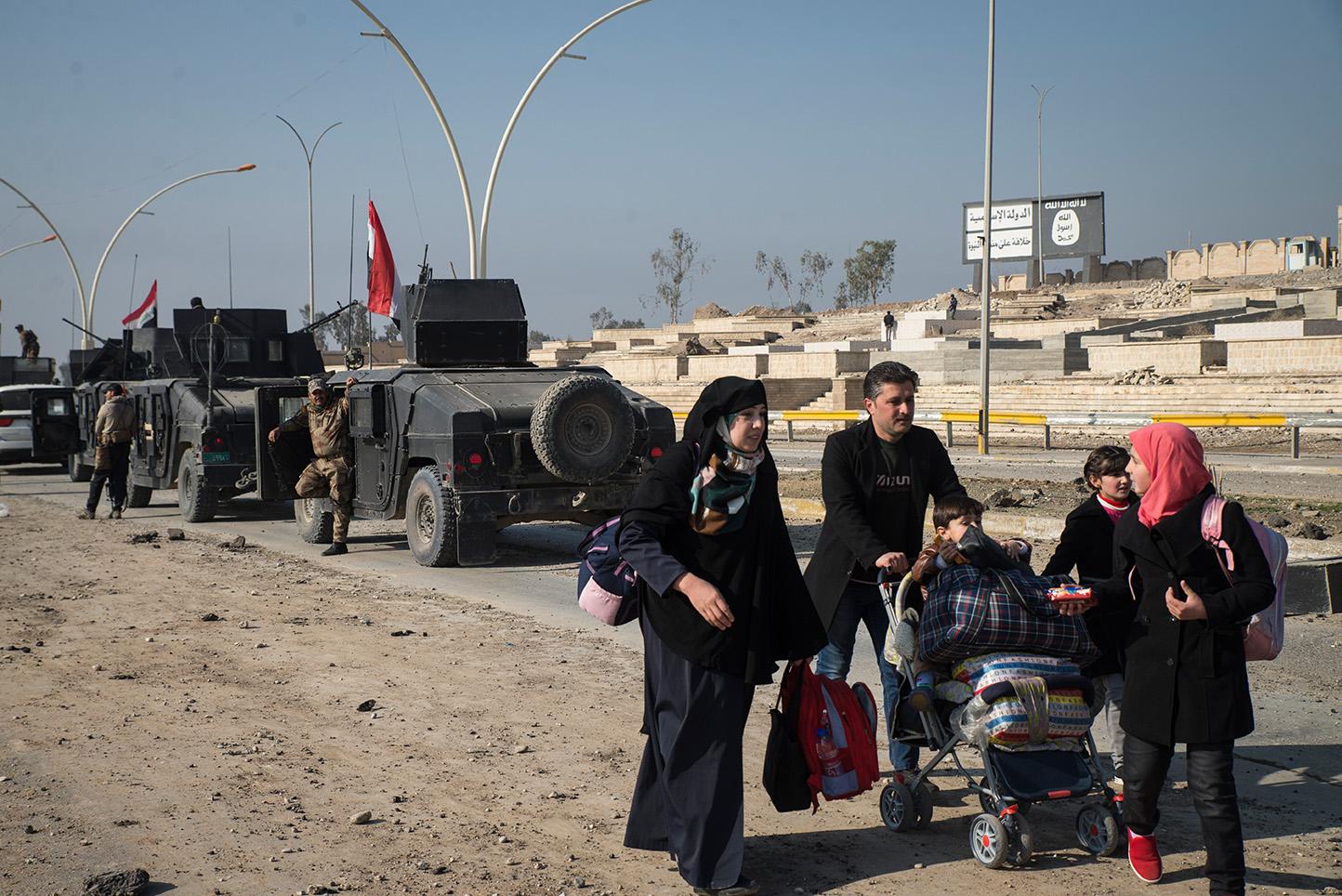 Mosul, Iraq. After two and half years under Islamic State Control civilians cross a bridge in...