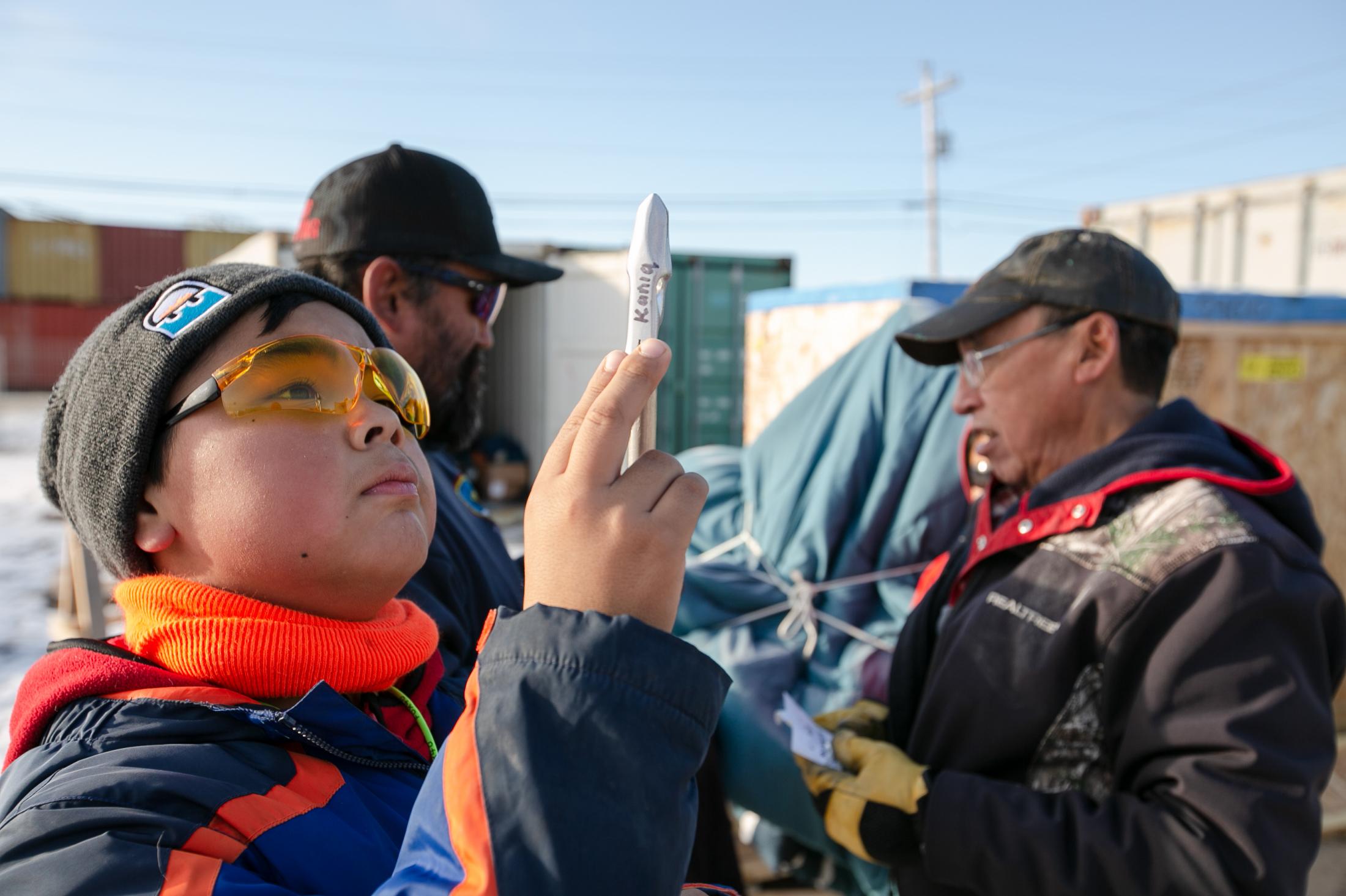 Nunavut's Young Hunters - Kaniq Allerton checks out his harpoon head before filing...