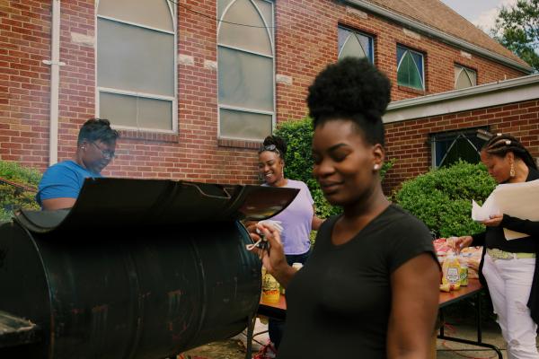 Image from Block Party for NYT - Joy Ligon and Nicole Holloway serve hotdogs and...