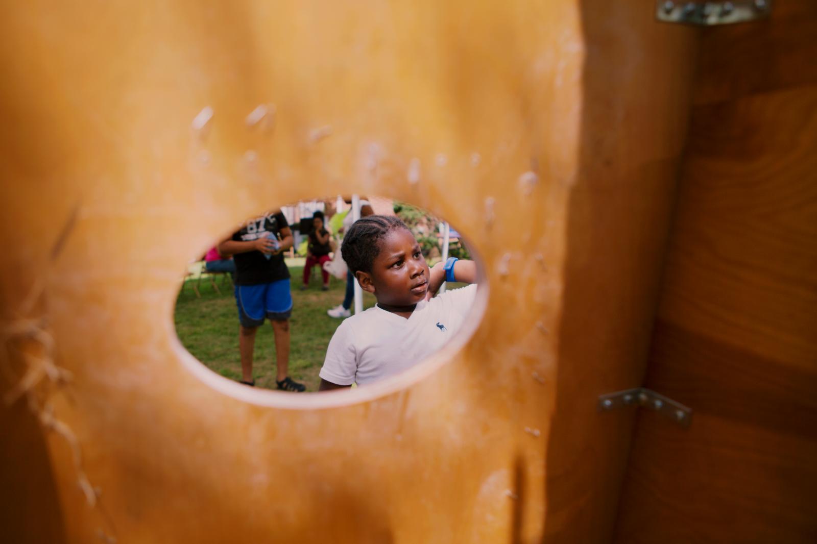 Isaac Walters, 5, plays Cornhole at the block party hosted by The Shiloh Baptist Church of...