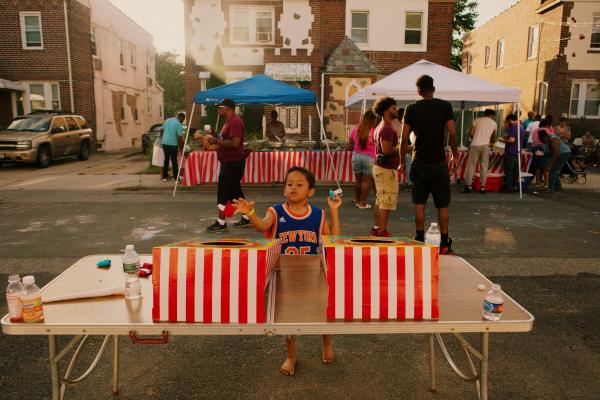 Block Party for NYT - Isaac Walters, 5, plays Cornhole at the block party...