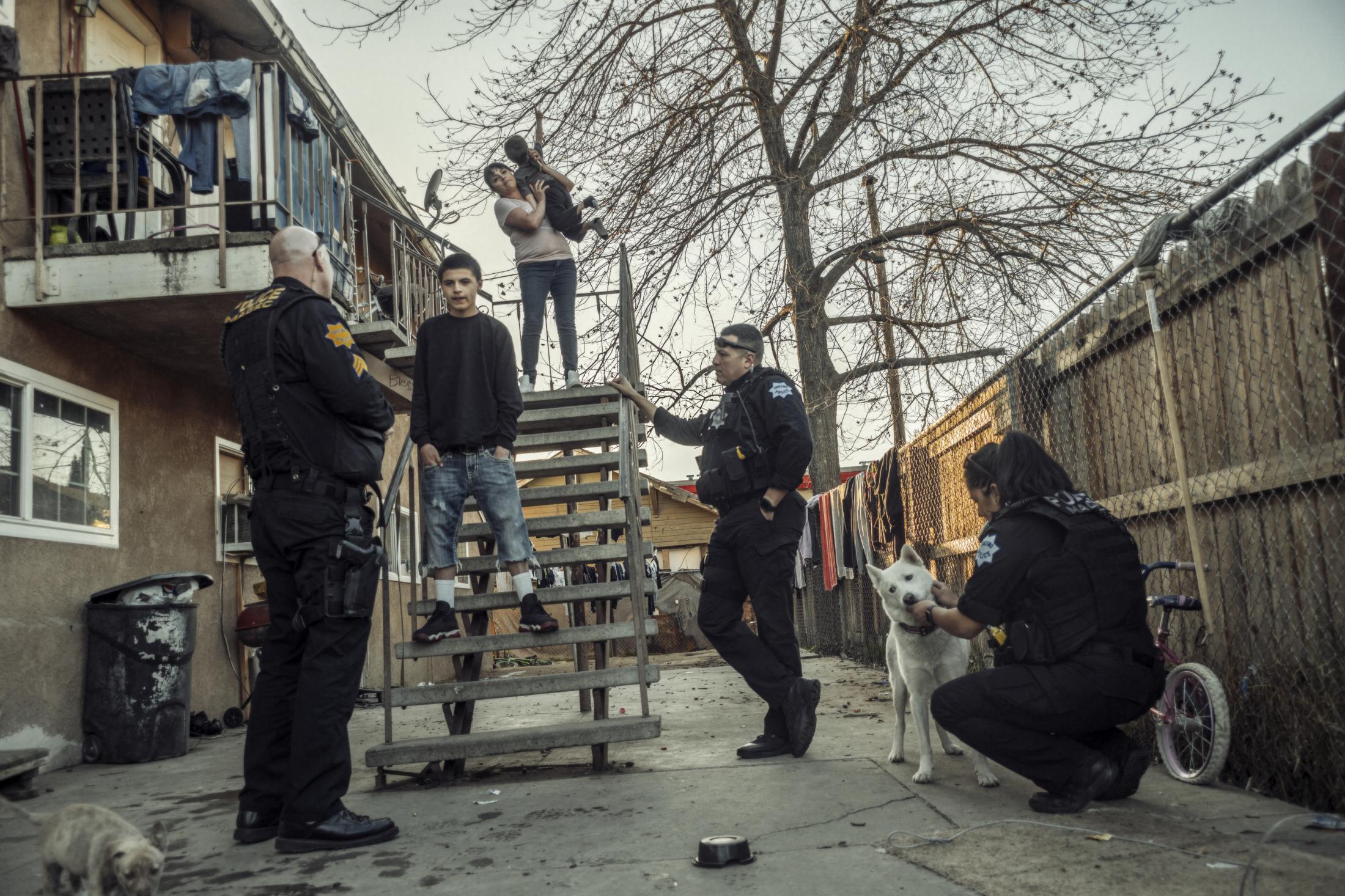 Coming of Age - Gang unit officers speak to residents after arresting an...