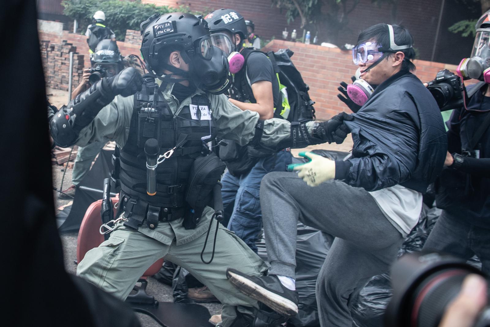 HONG KONG, CHINA - NOVEMBER 18: Police arrest anti-government protesters at Hong Kong Polytechnic University on November 18, 2019 in Hong Kong, China. Anti-government protesters organized a general strike since Monday as demonstrations in Hong Kong stretched into its sixth month with demands for an independent inquiry into police brutality, the retraction of the word &quot;riot&quot; to describe the rallies, and genuine universal suffrage. (Photo by Laurel Chor/Getty Images)